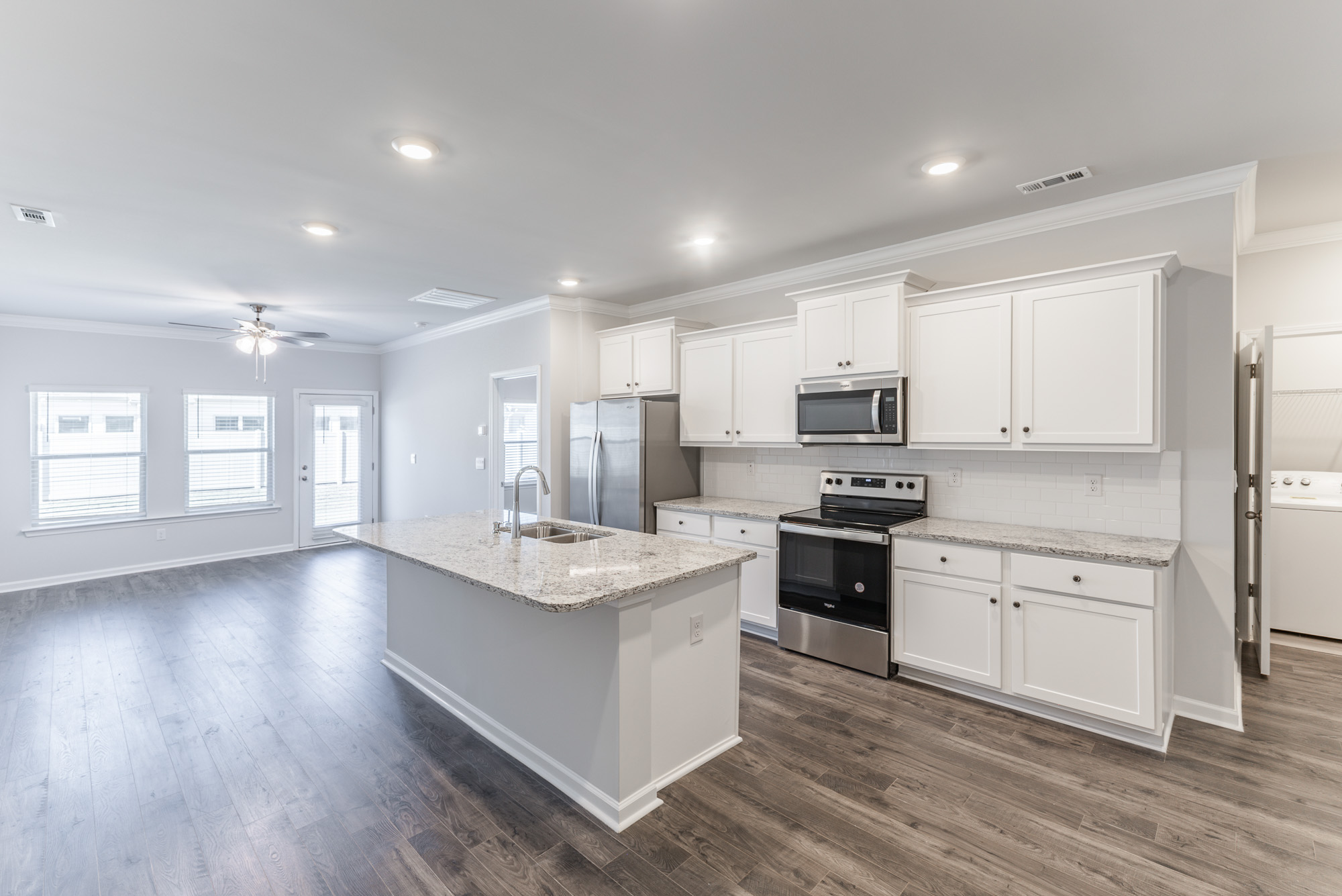 a kitchen with an island in the middle of a room