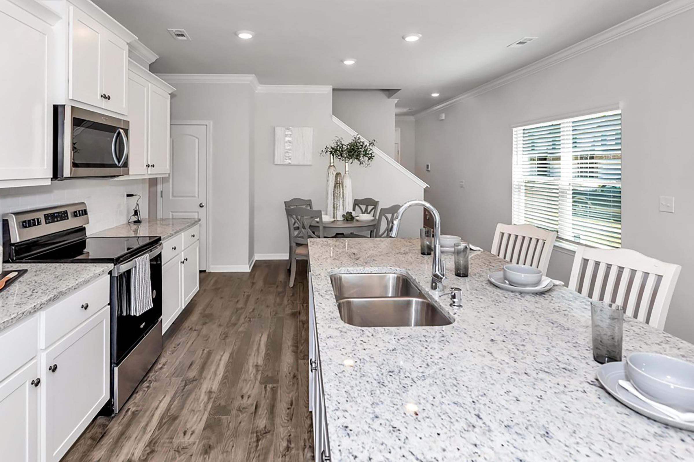 a kitchen with an island in the middle of a room