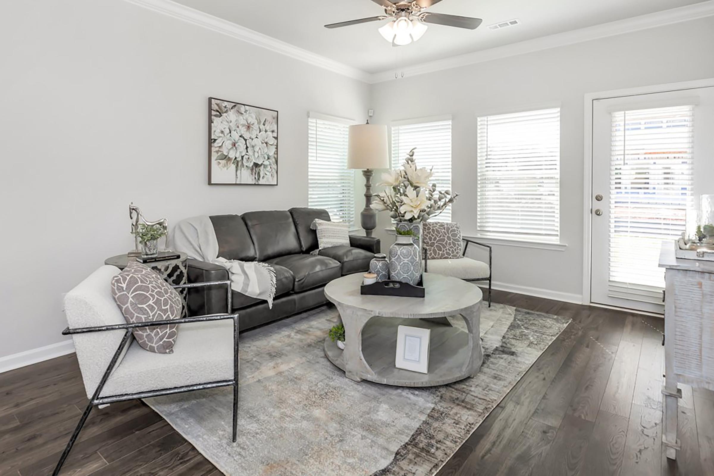 a living room filled with furniture and a large window