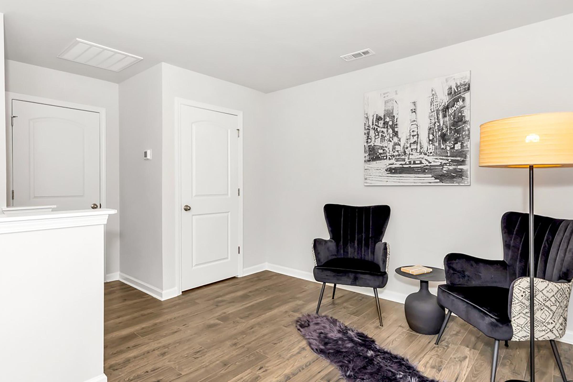 a living room filled with furniture and a flat screen tv