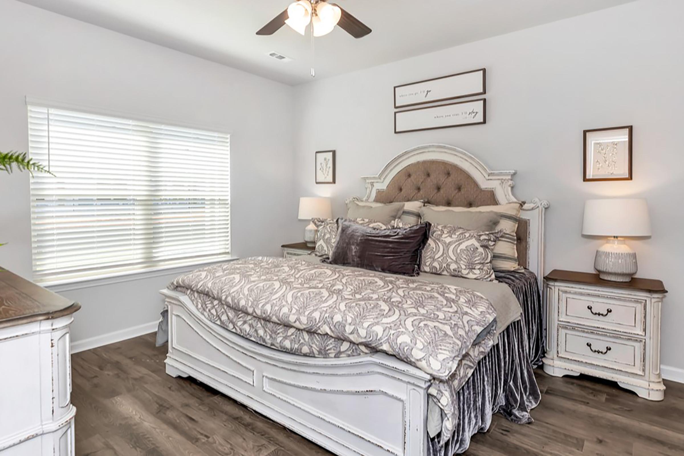 a bedroom with a bed and desk in a room