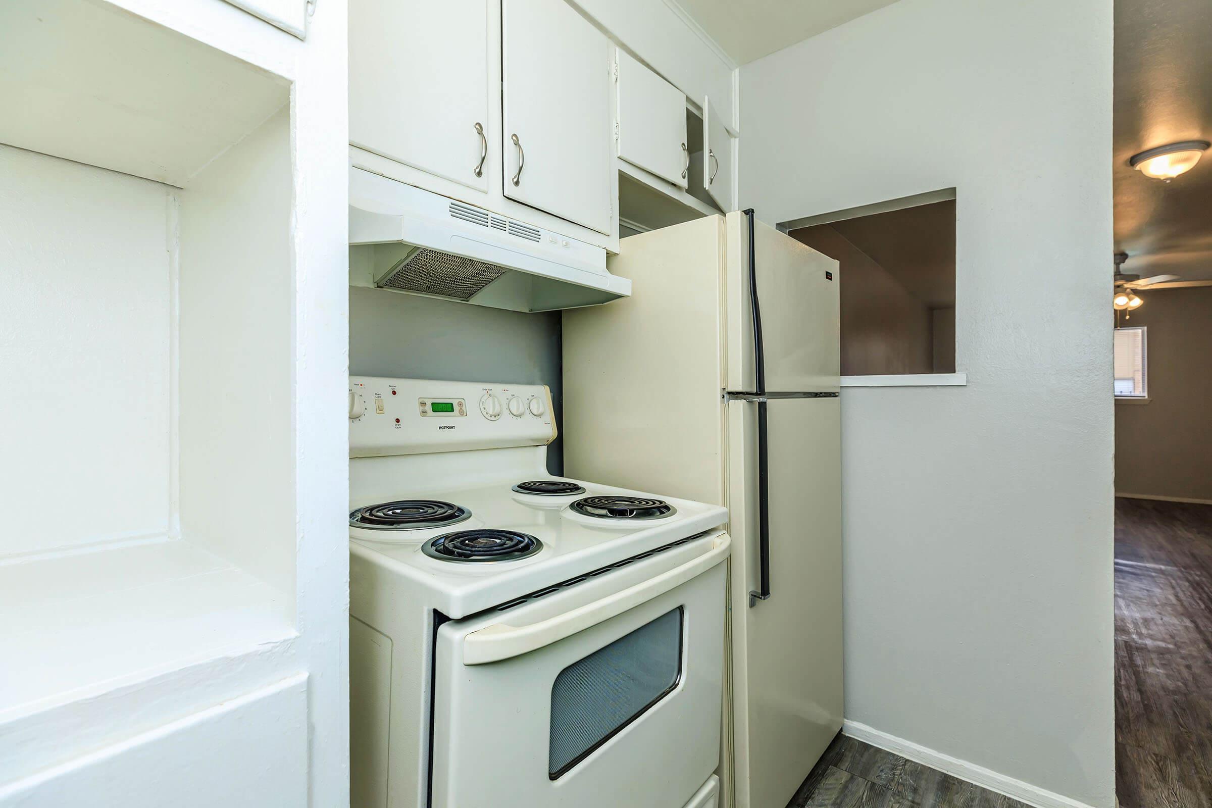 a stove top oven sitting inside of a kitchen