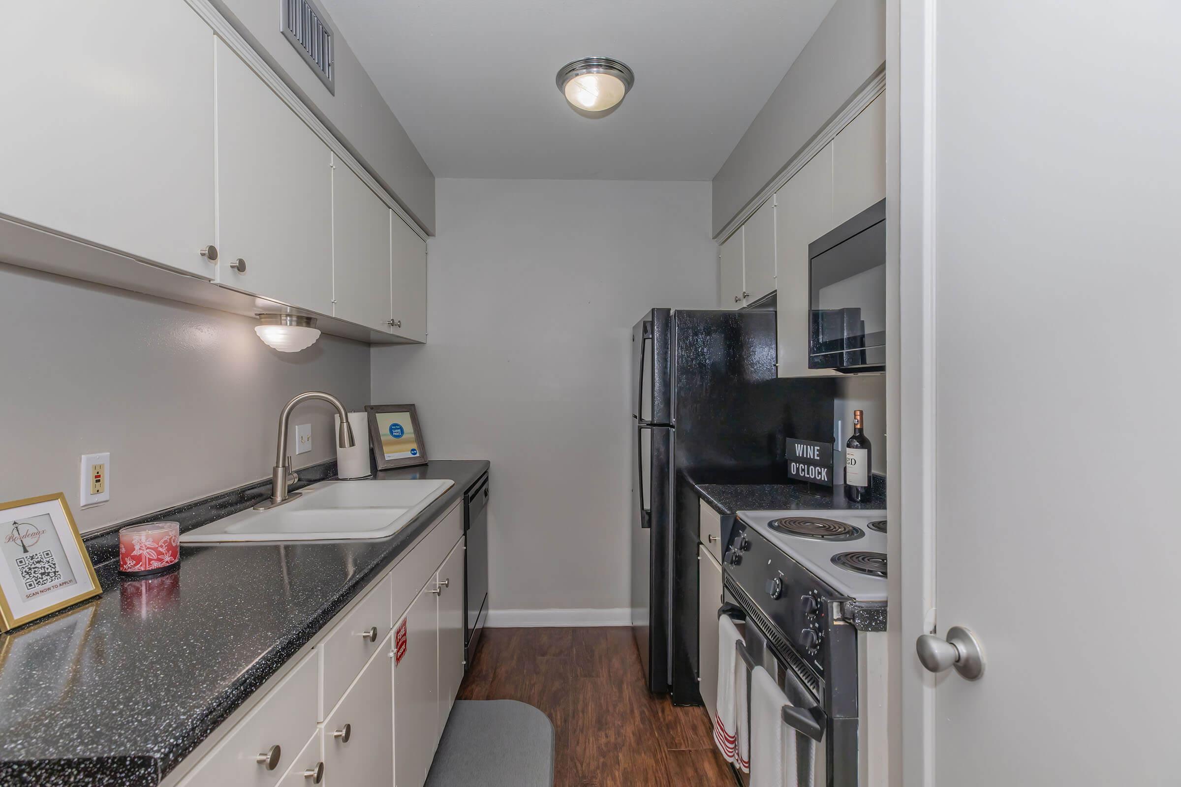 a kitchen with a sink and a refrigerator