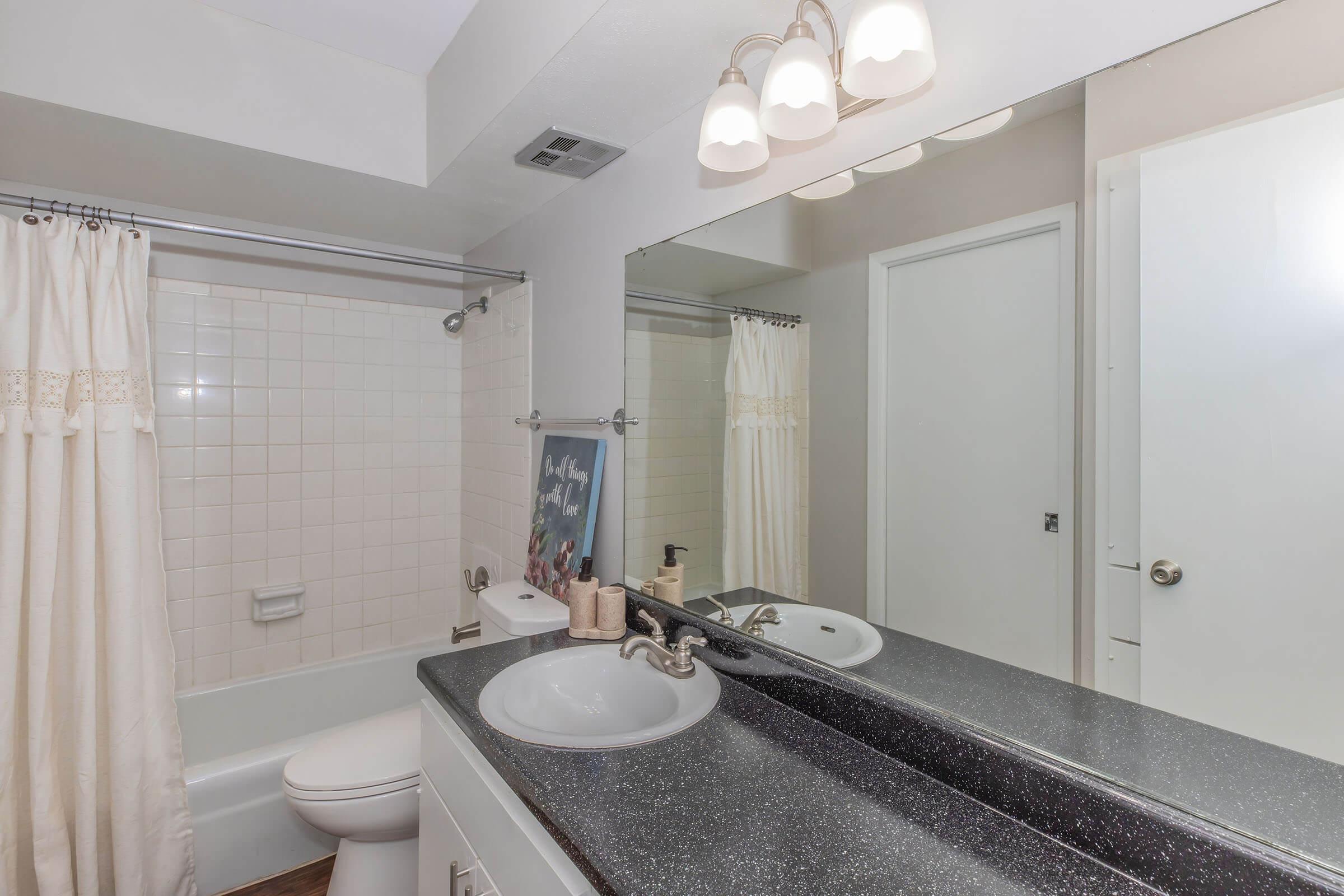 a shower that has a sink and a mirror