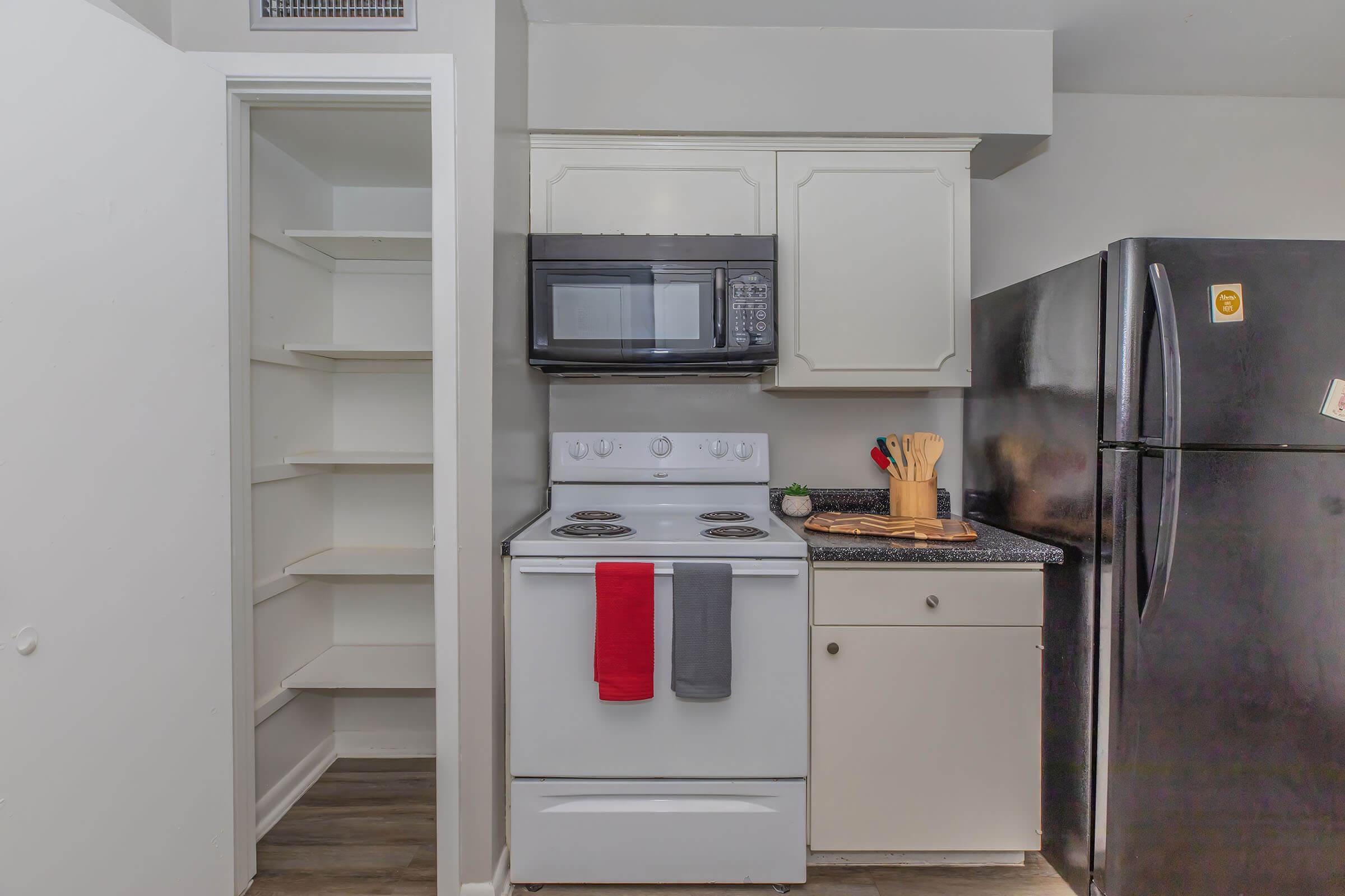 a microwave oven sitting on top of a refrigerator