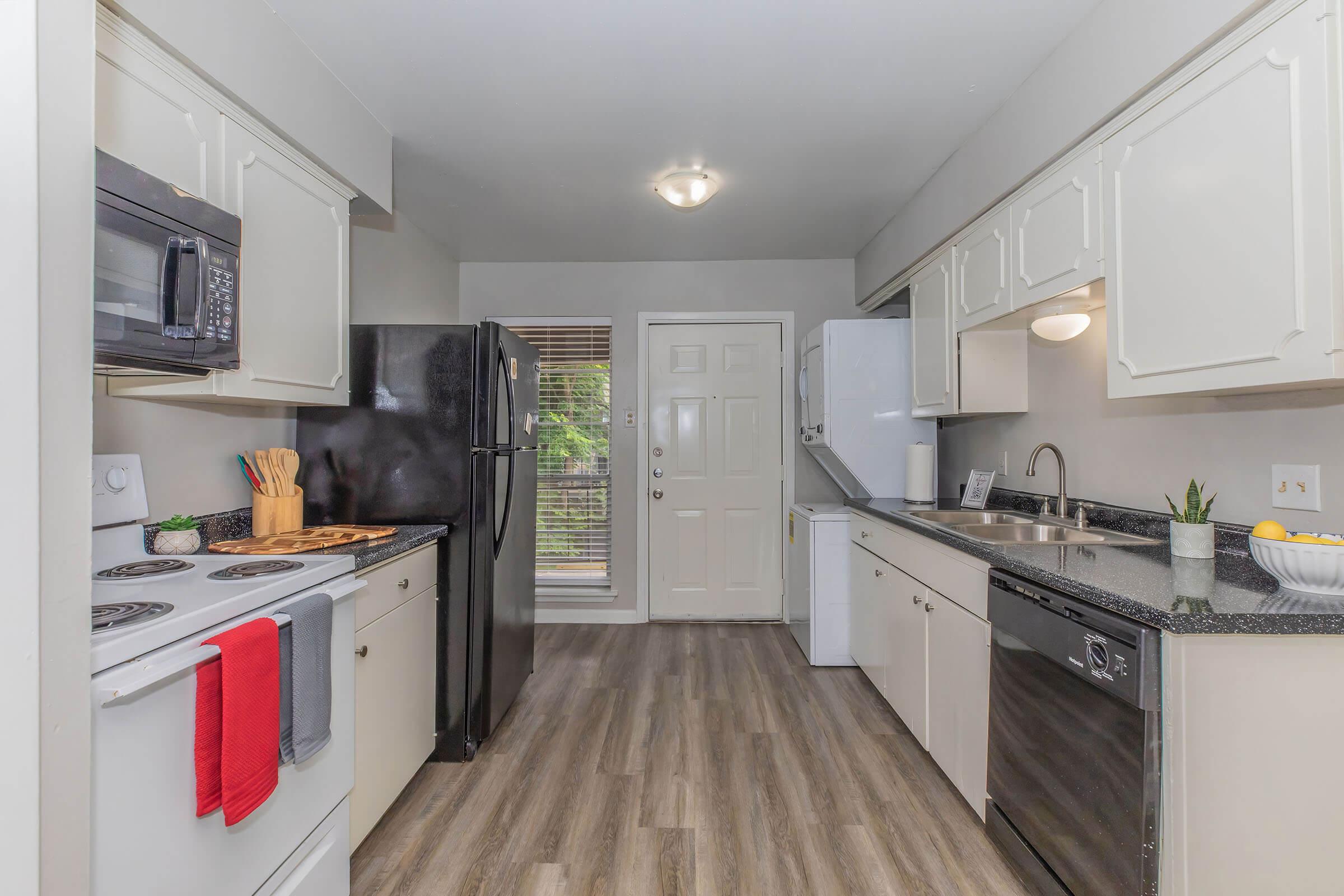 a kitchen with a stove sink and refrigerator