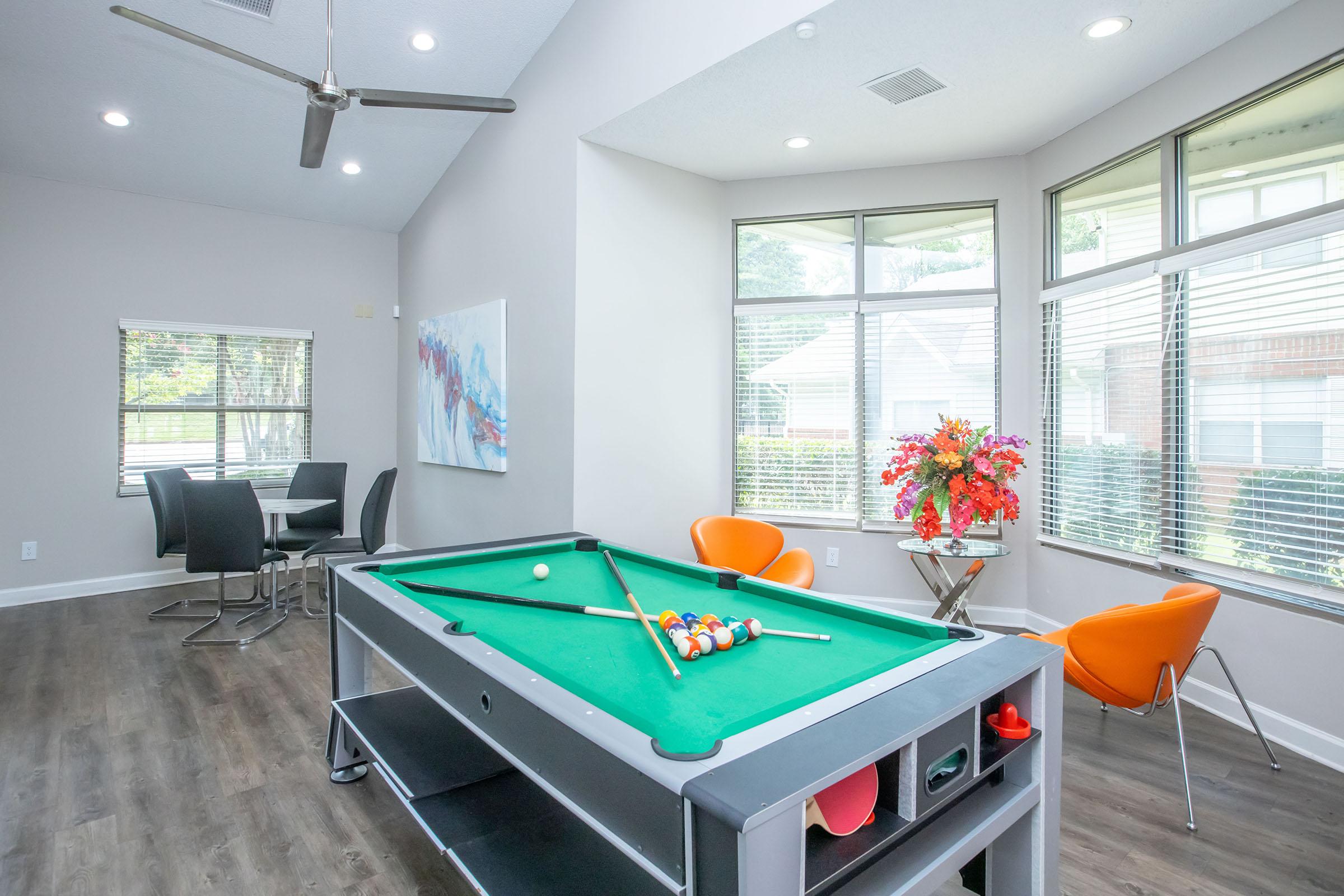 a living room filled with furniture and a large window