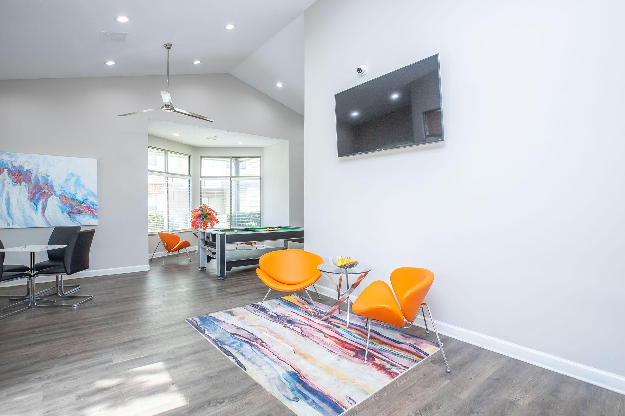 a living room with orange furniture