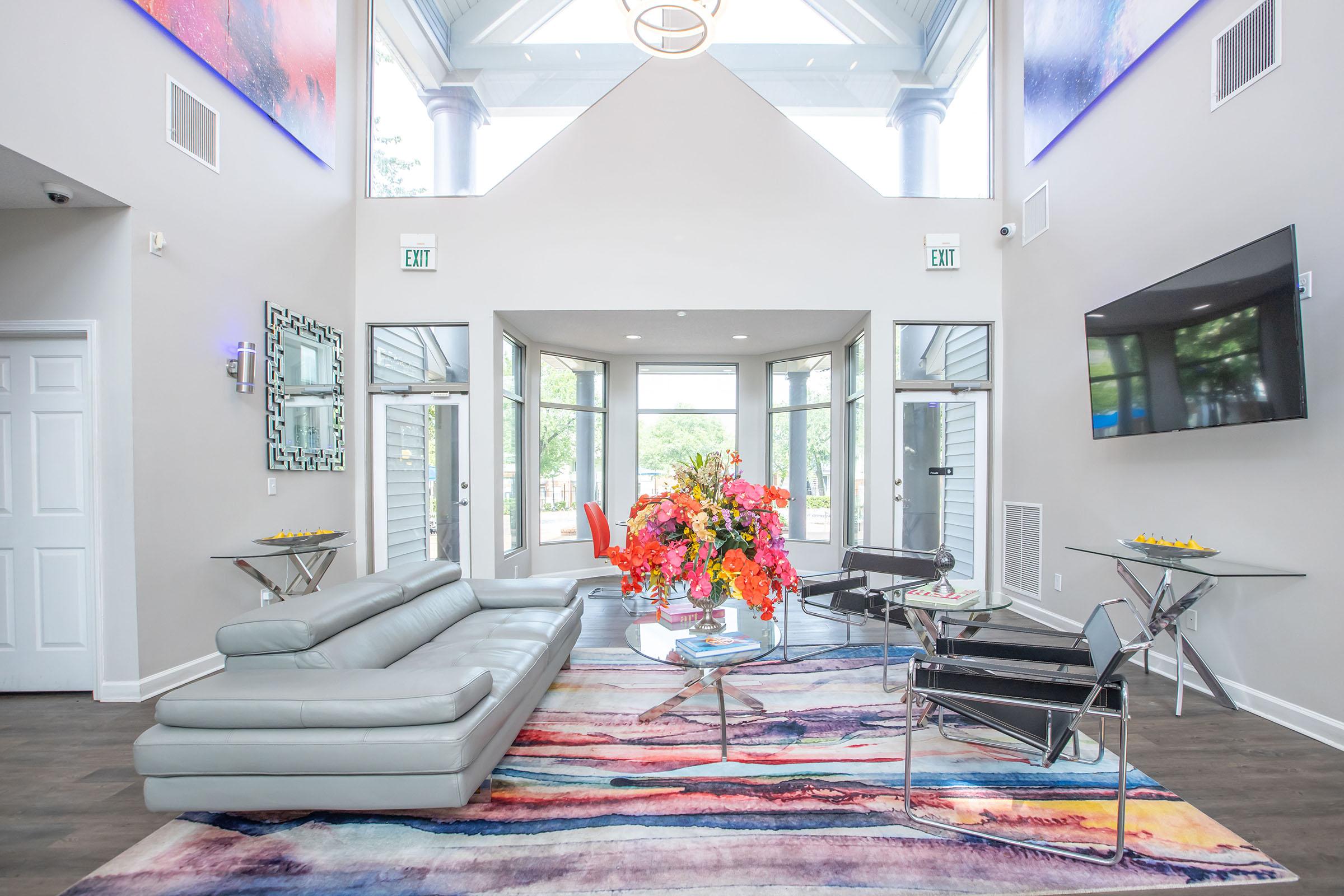 a living room filled with furniture and a large window