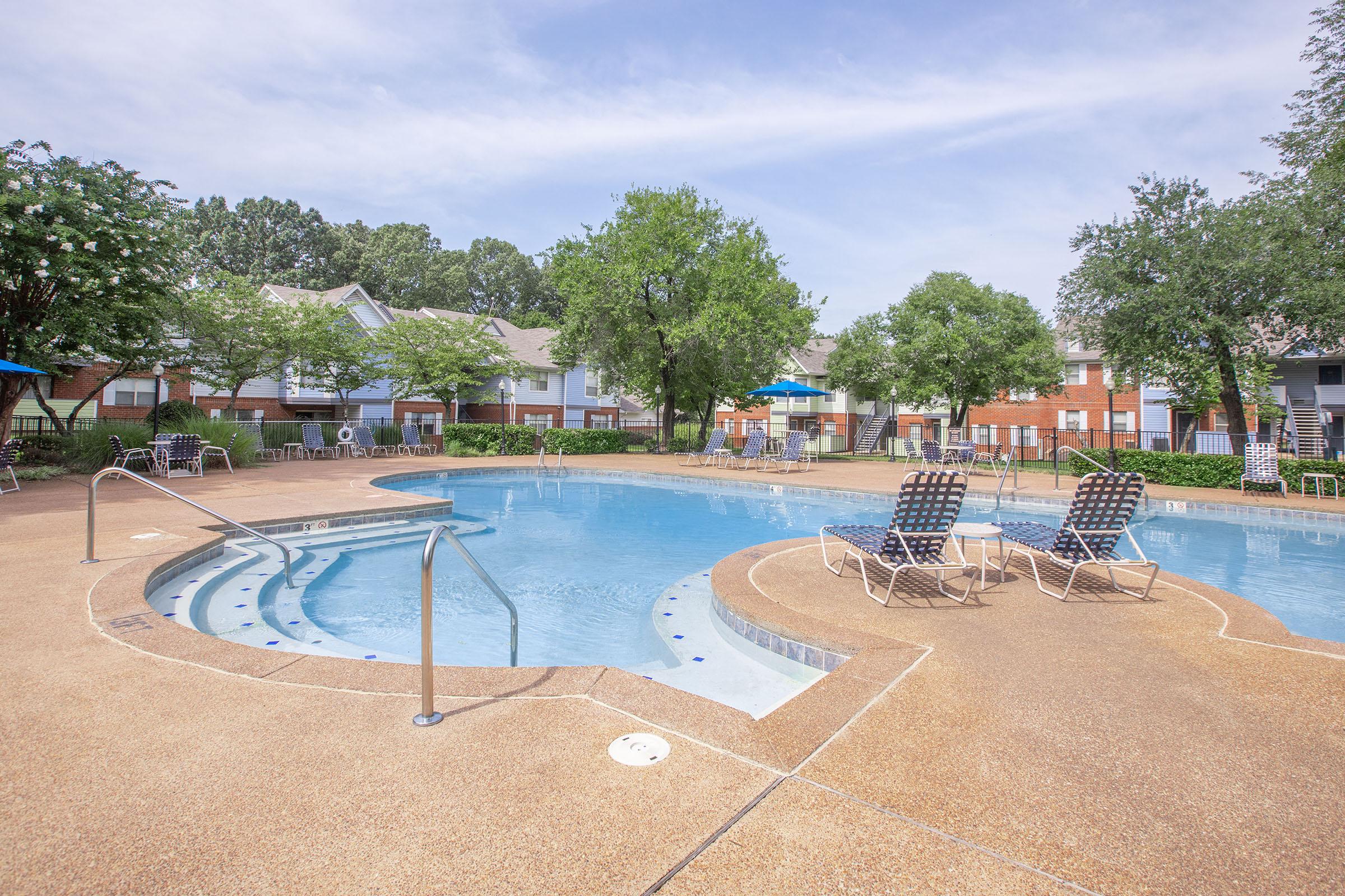 a sandy beach next to a pool of water