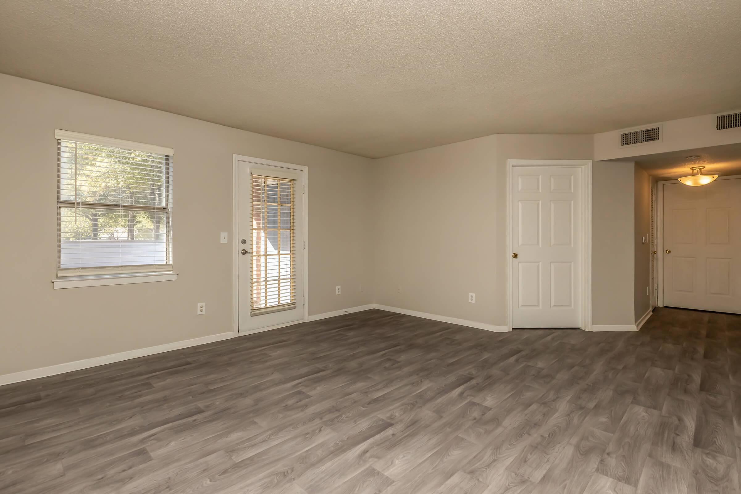 a large empty room with a wood floor