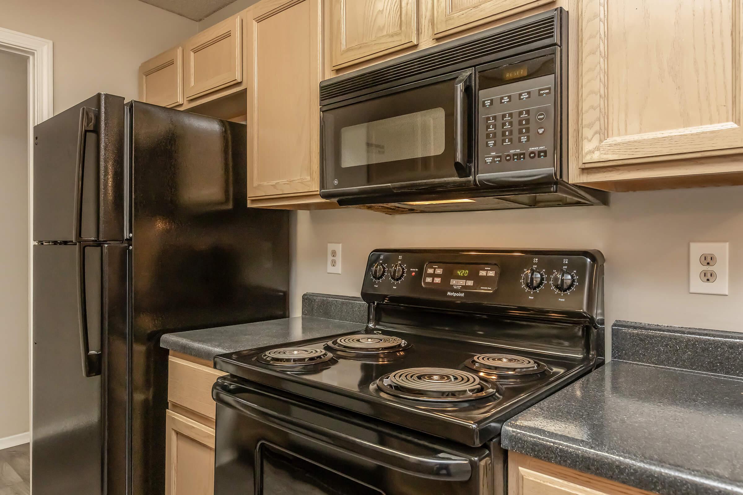 a stove top oven sitting inside of a kitchen