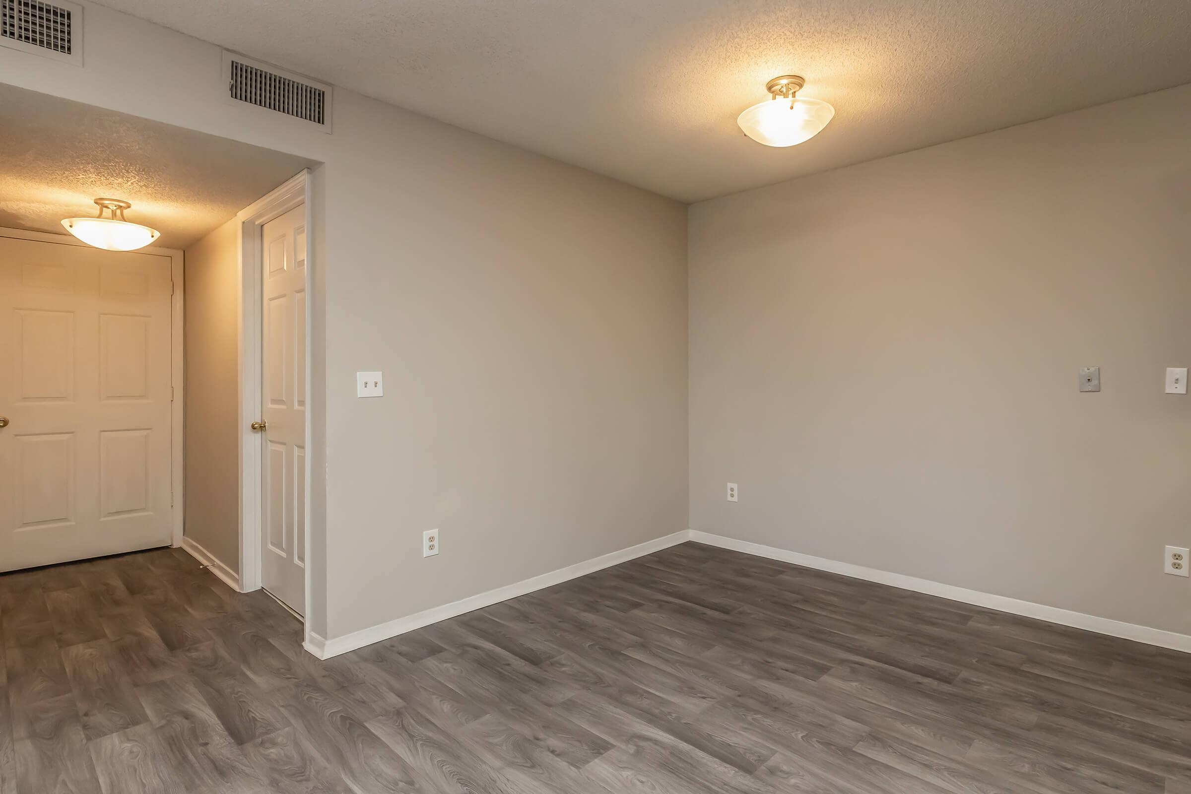 a large empty room with a wood floor