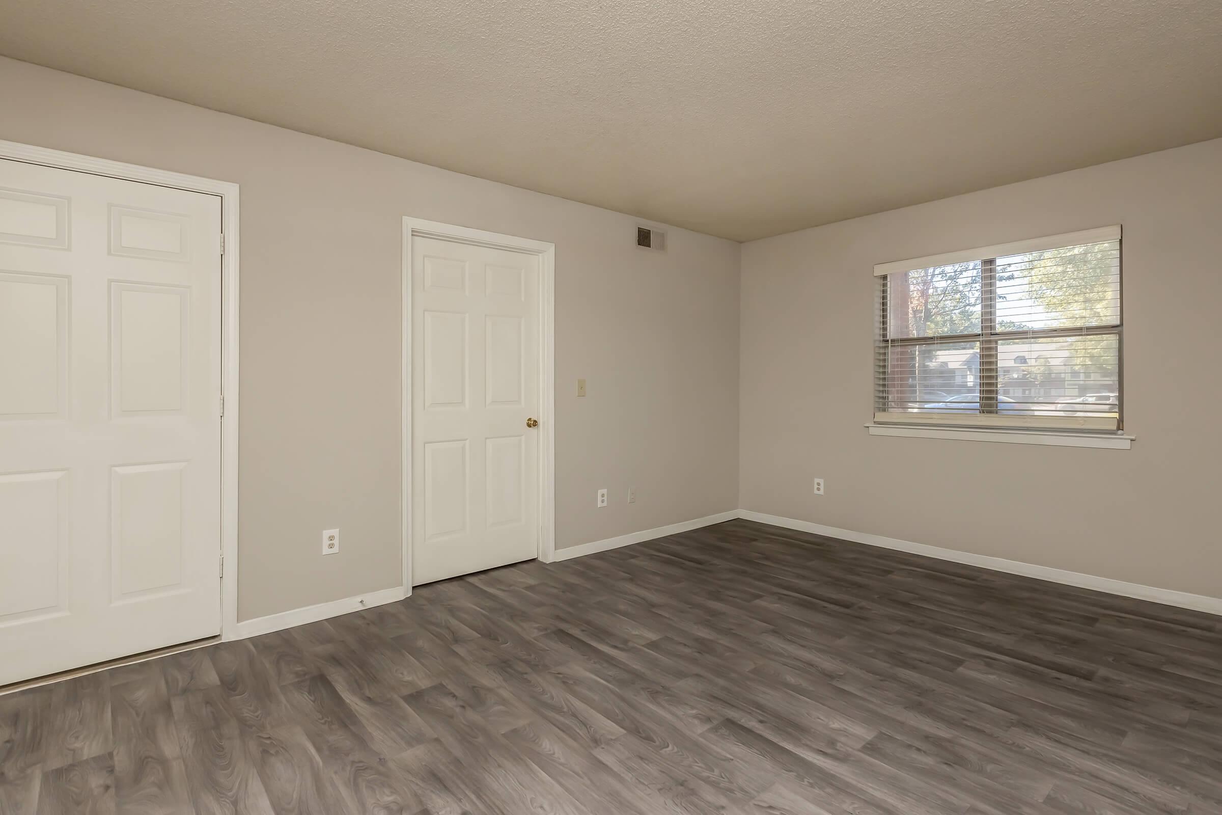 a large empty room with a wood floor