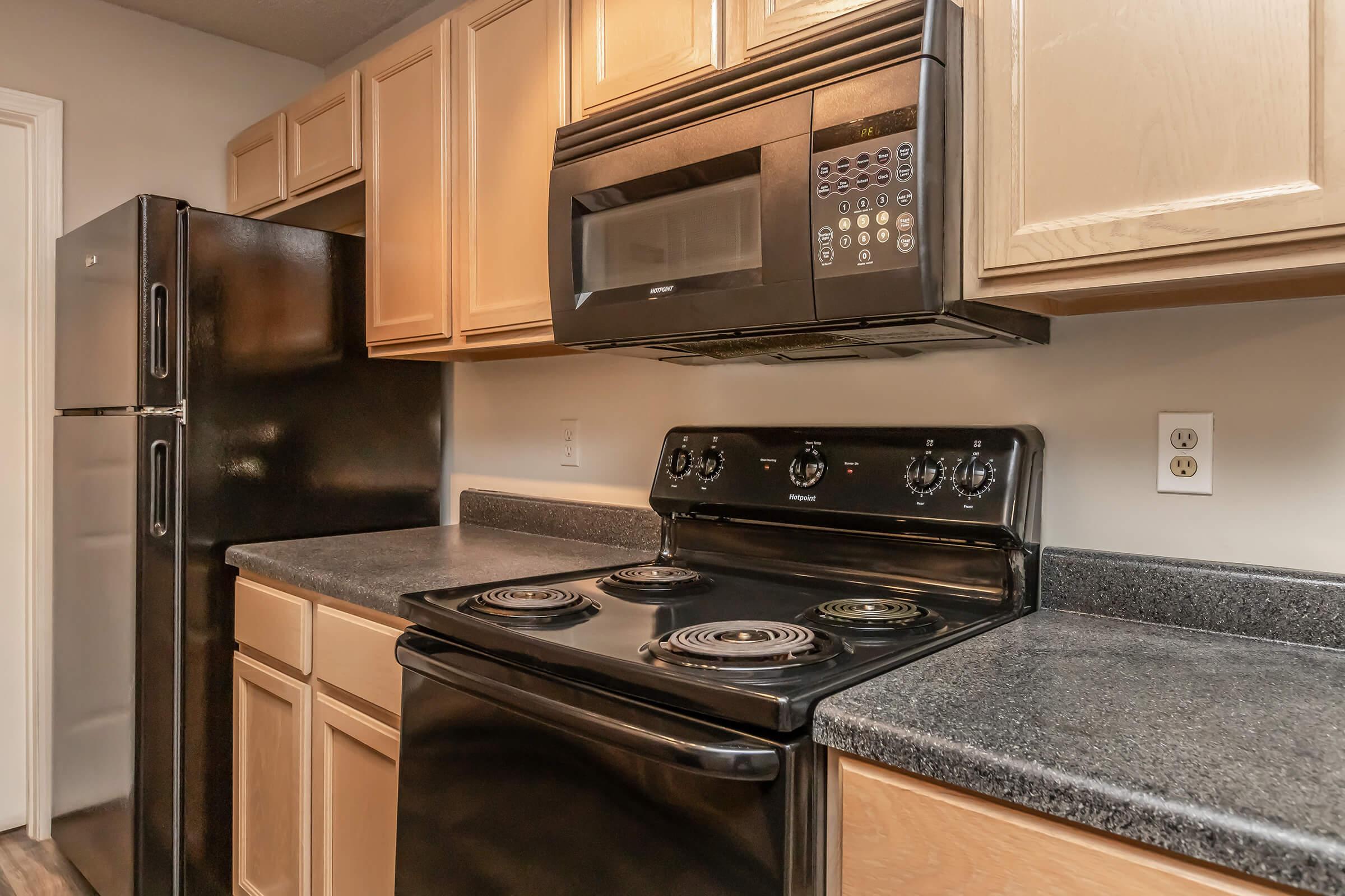 a stove top oven sitting inside of a kitchen