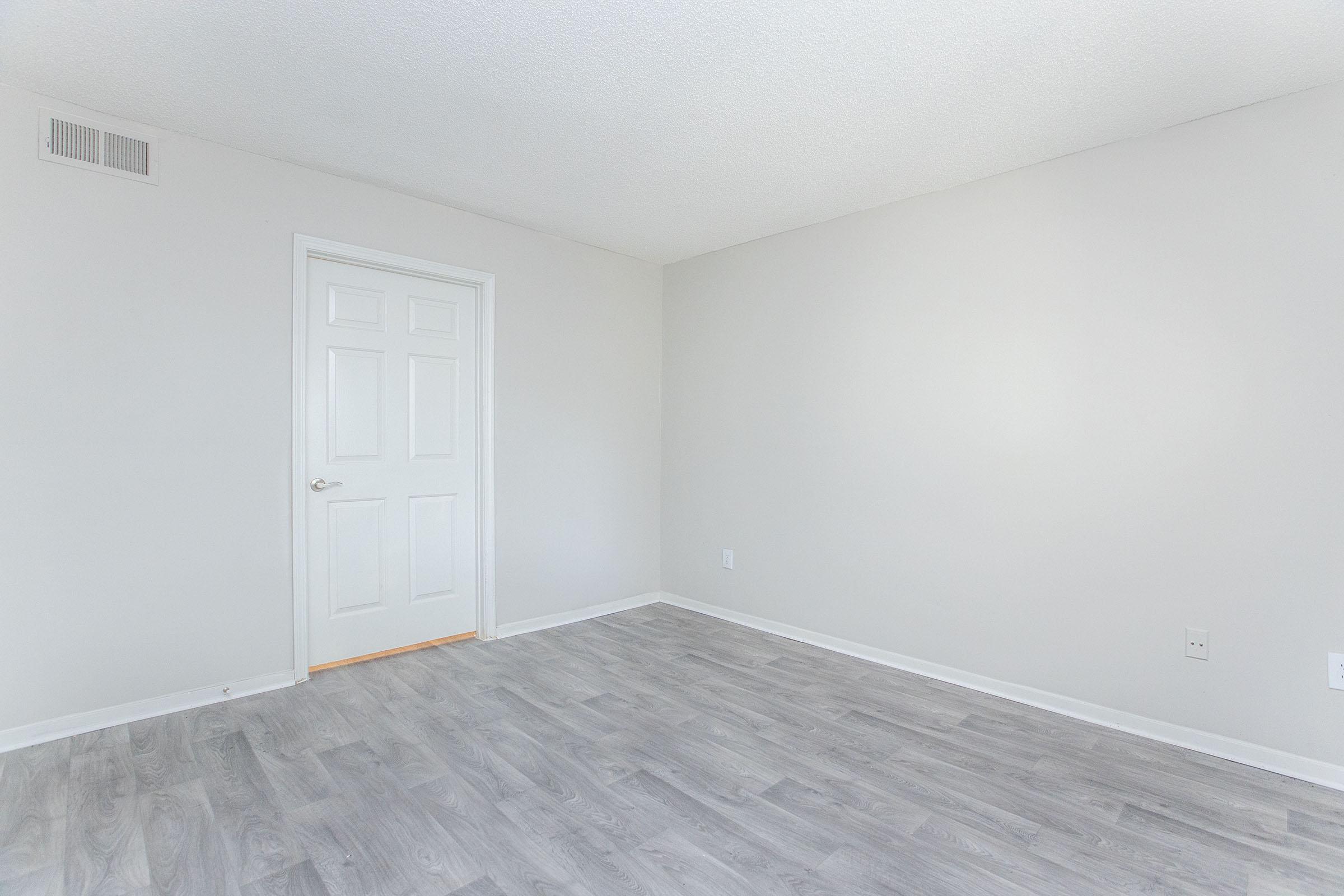 a bedroom with a building in the background