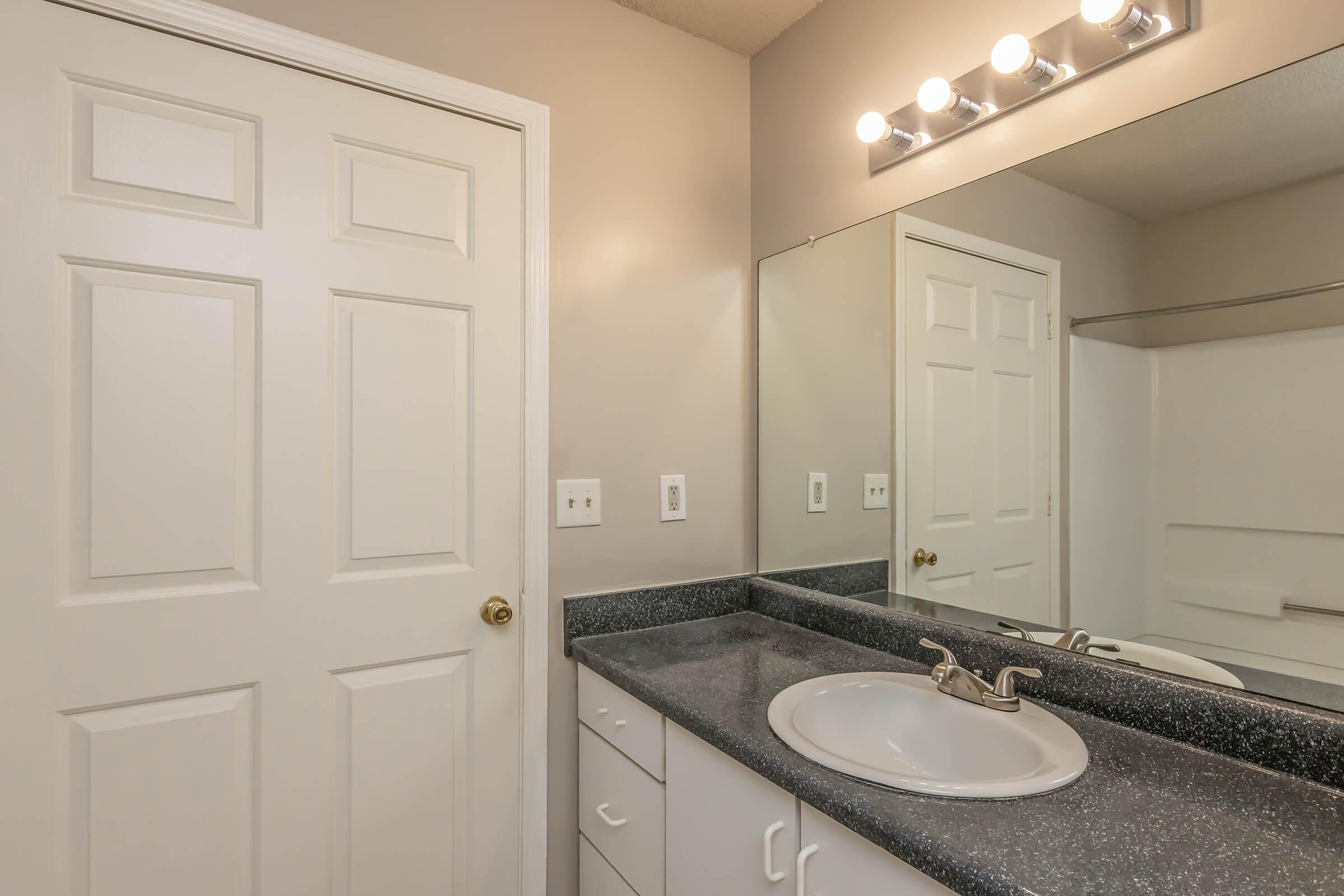 a kitchen with a sink and a mirror