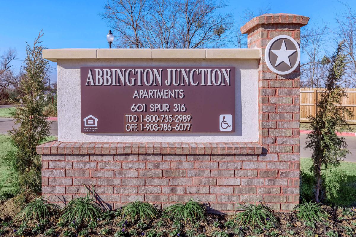 a sign in front of a brick building