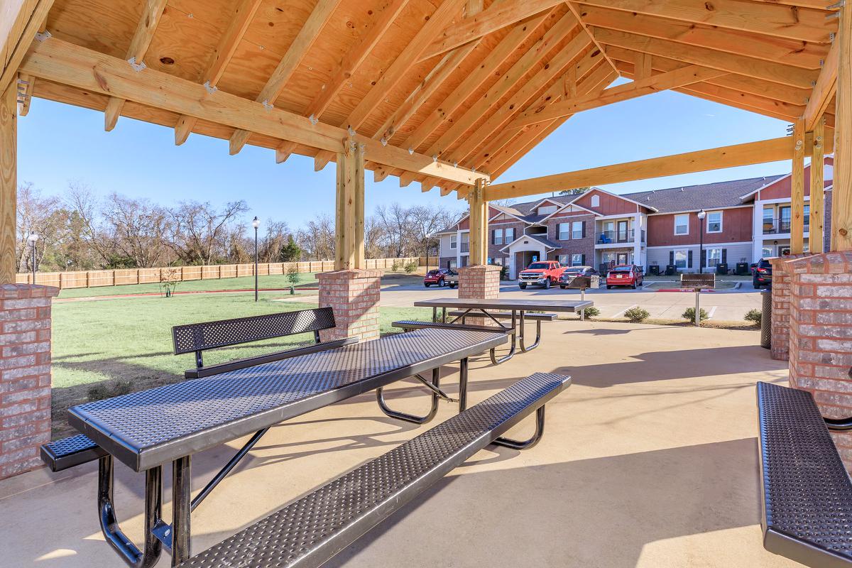 a wooden bench sitting in front of a building