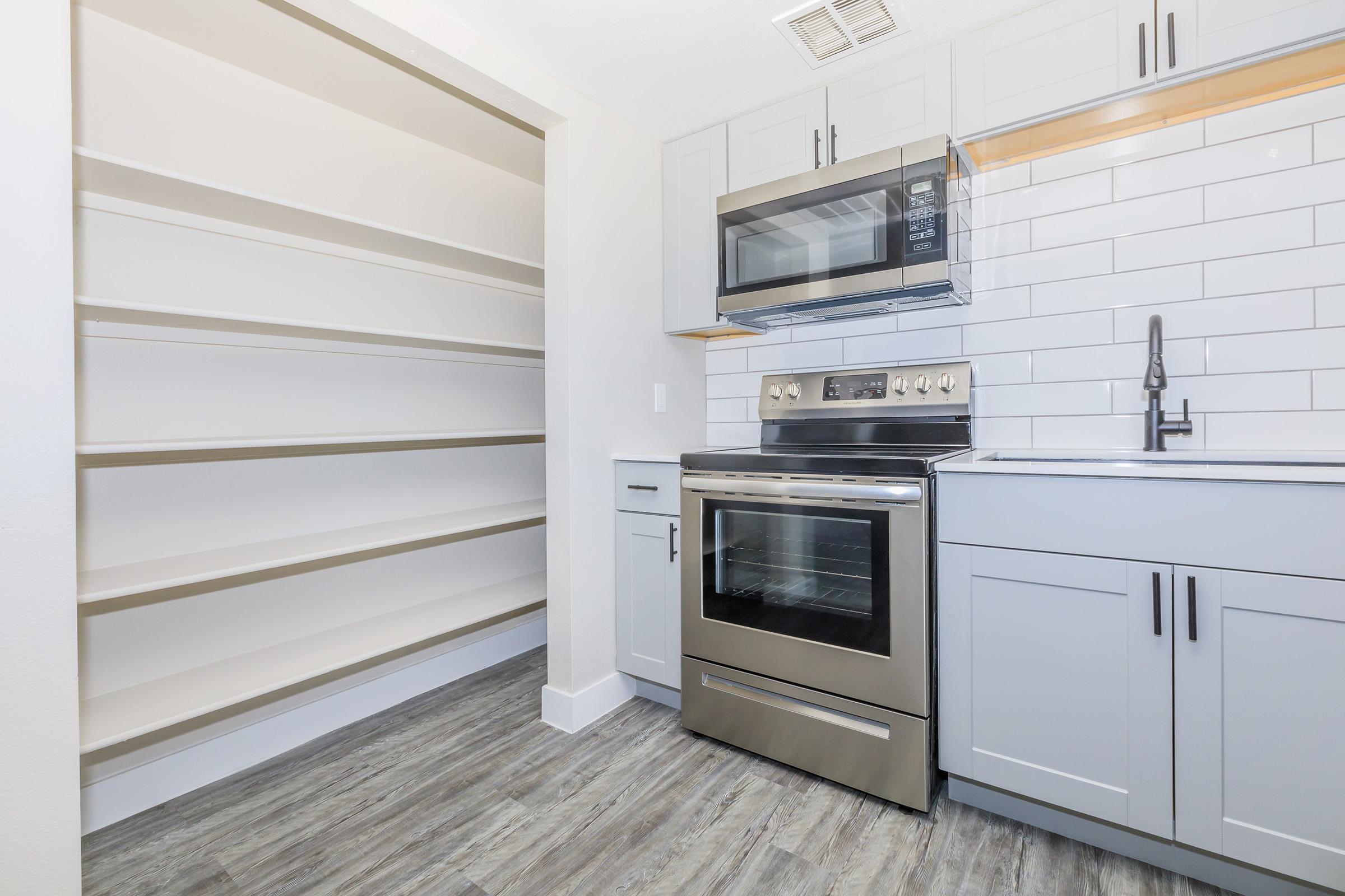 a stove top oven sitting inside of a kitchen