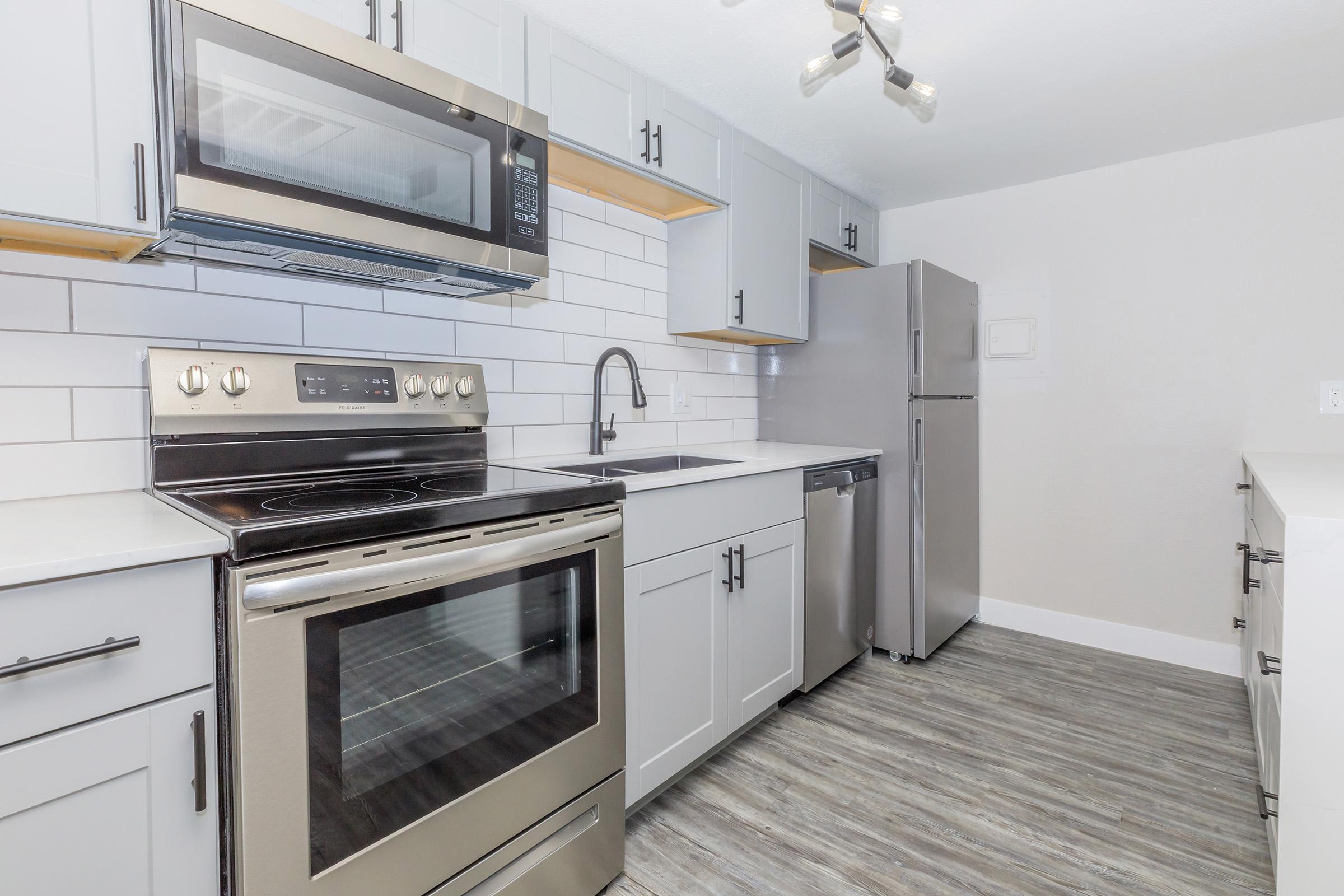 a stove top oven sitting inside of a kitchen