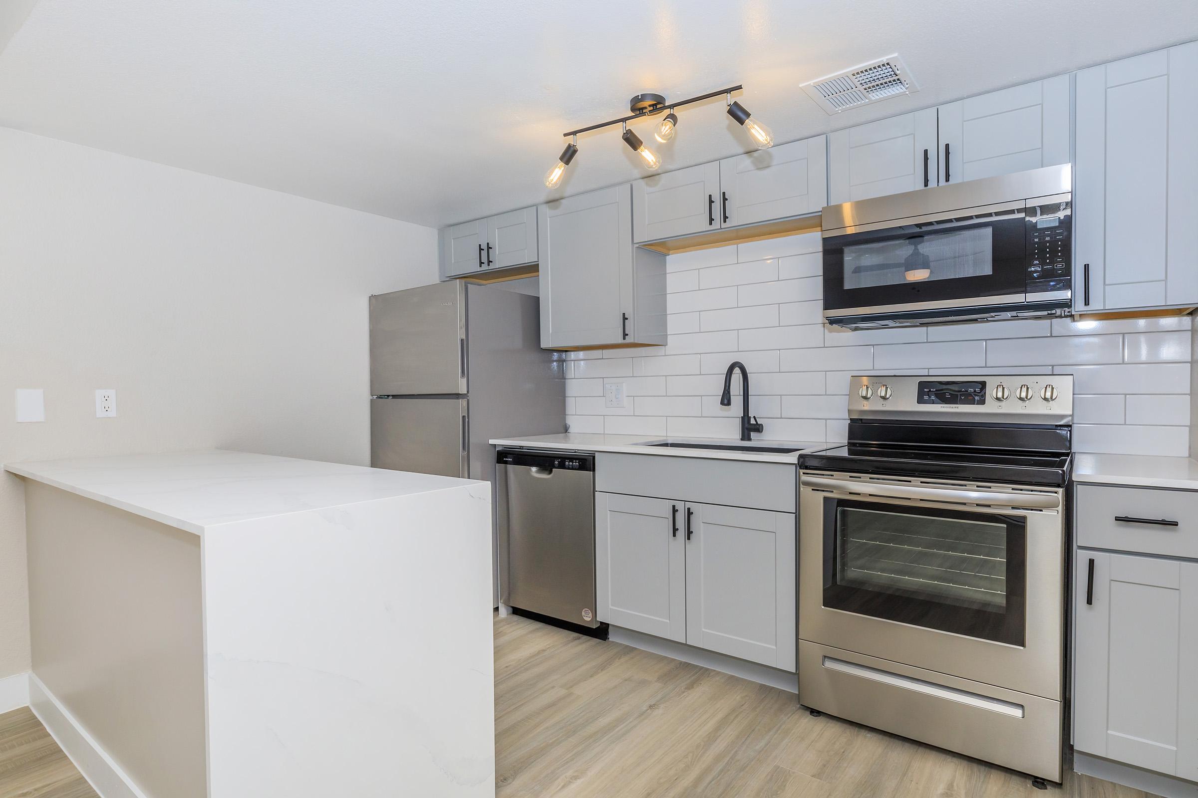 a stove top oven sitting inside of a kitchen