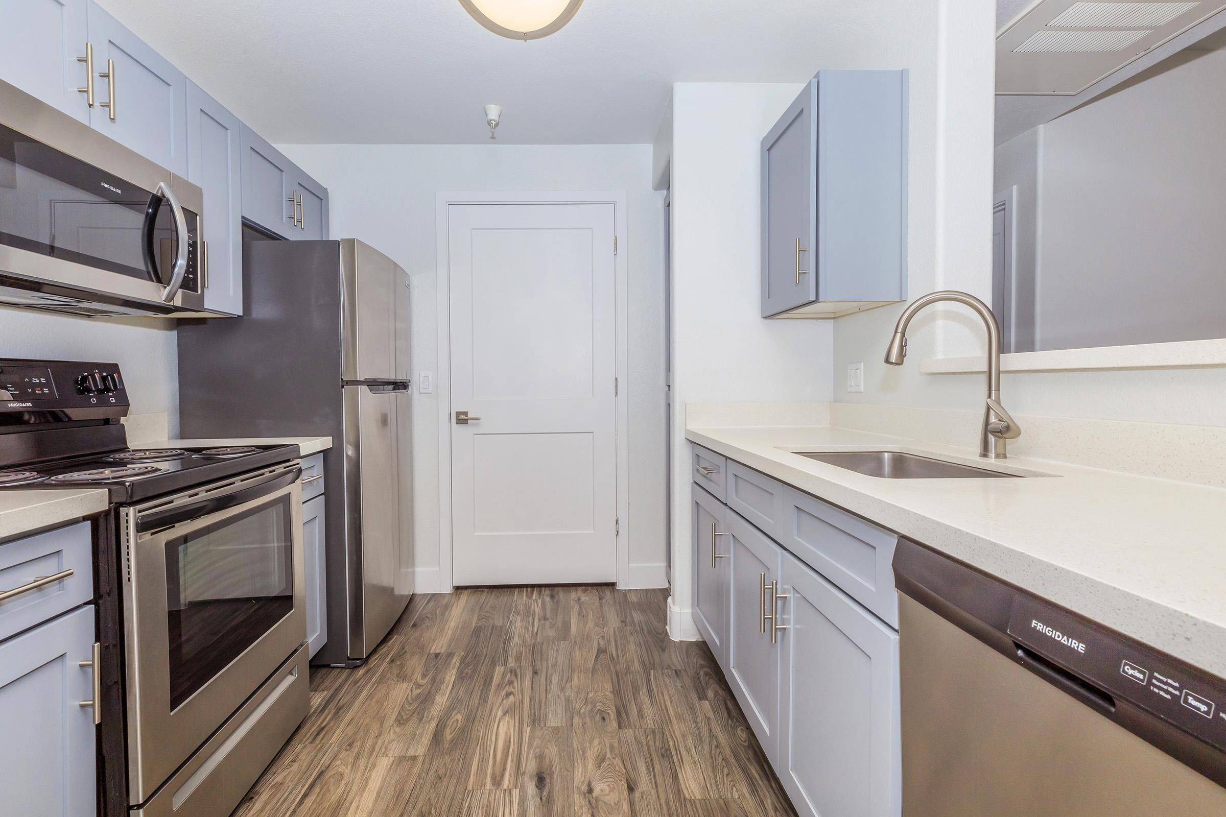 a stove top oven sitting inside of a kitchen