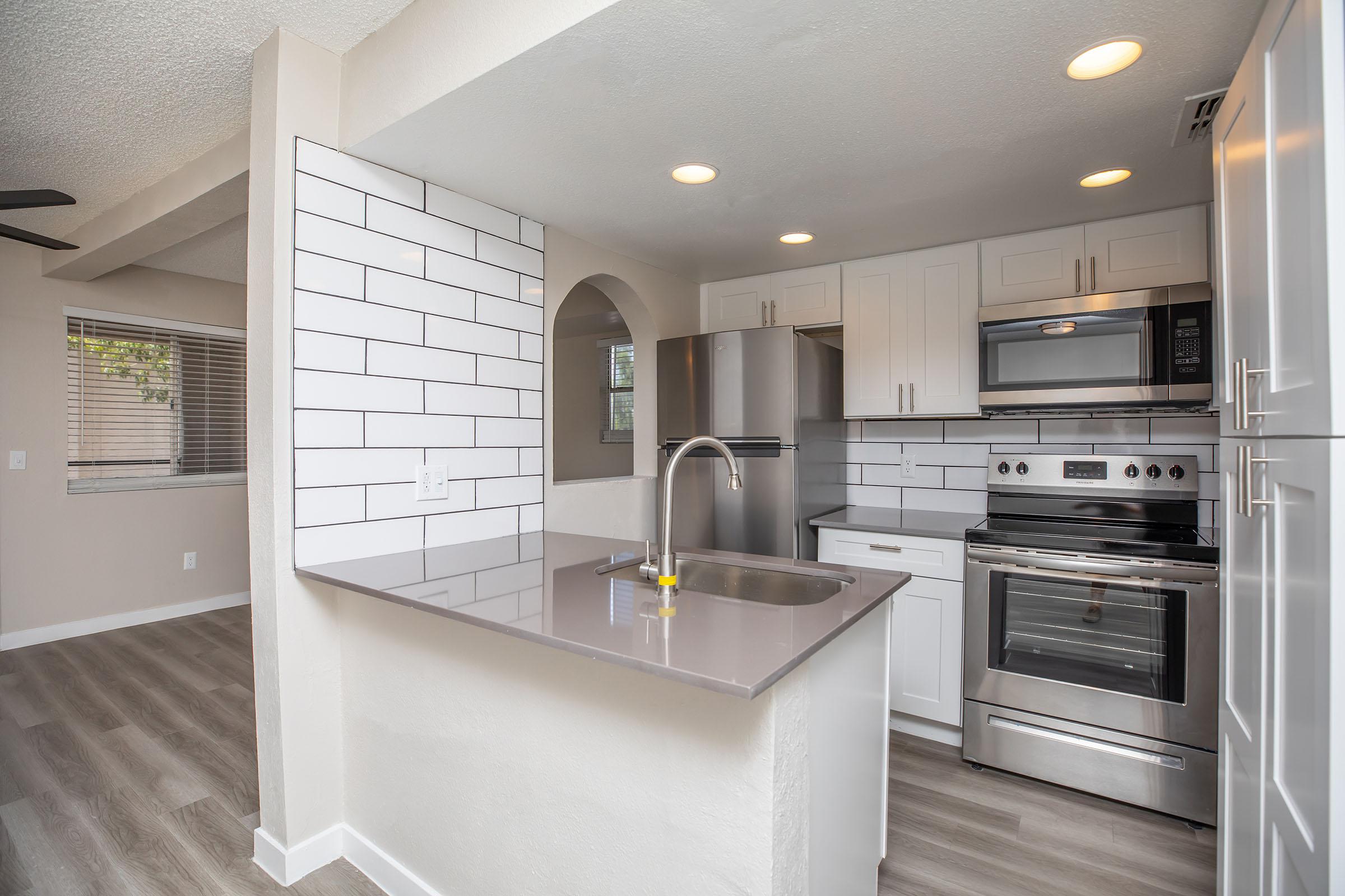 a modern kitchen with stainless steel appliances