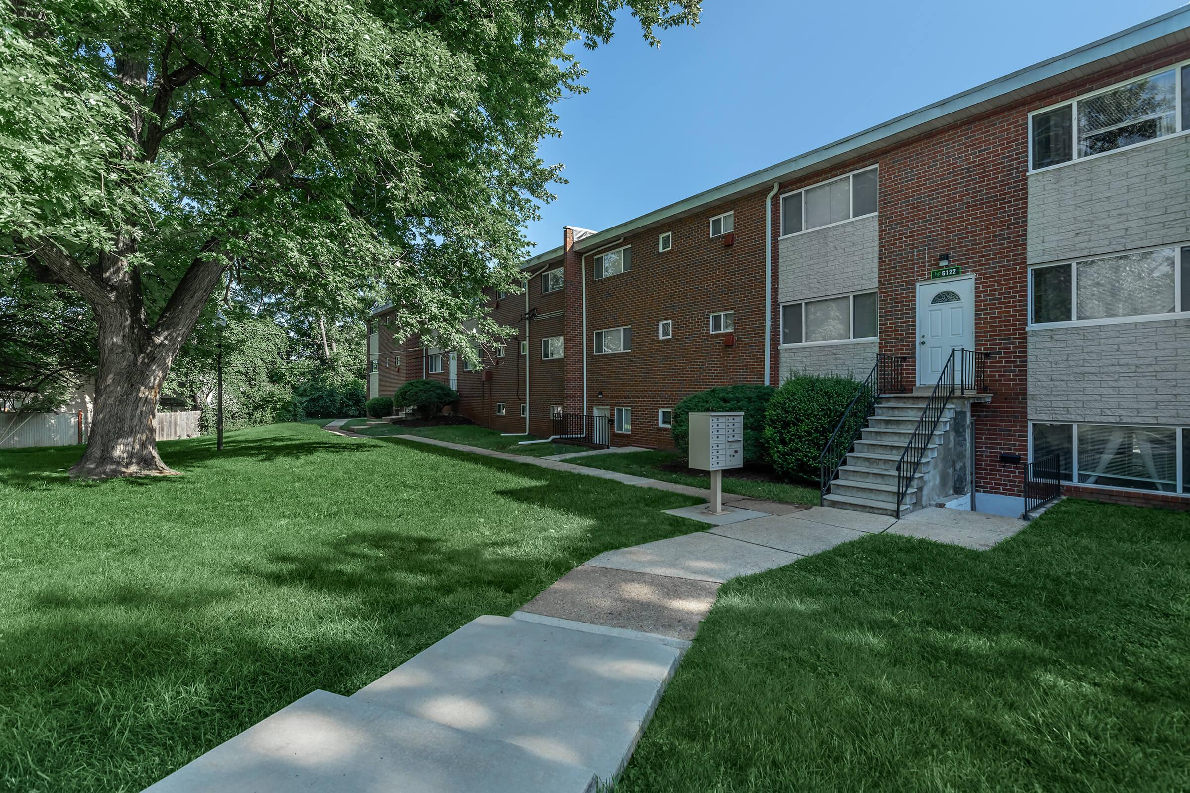 a large lawn in front of a brick building