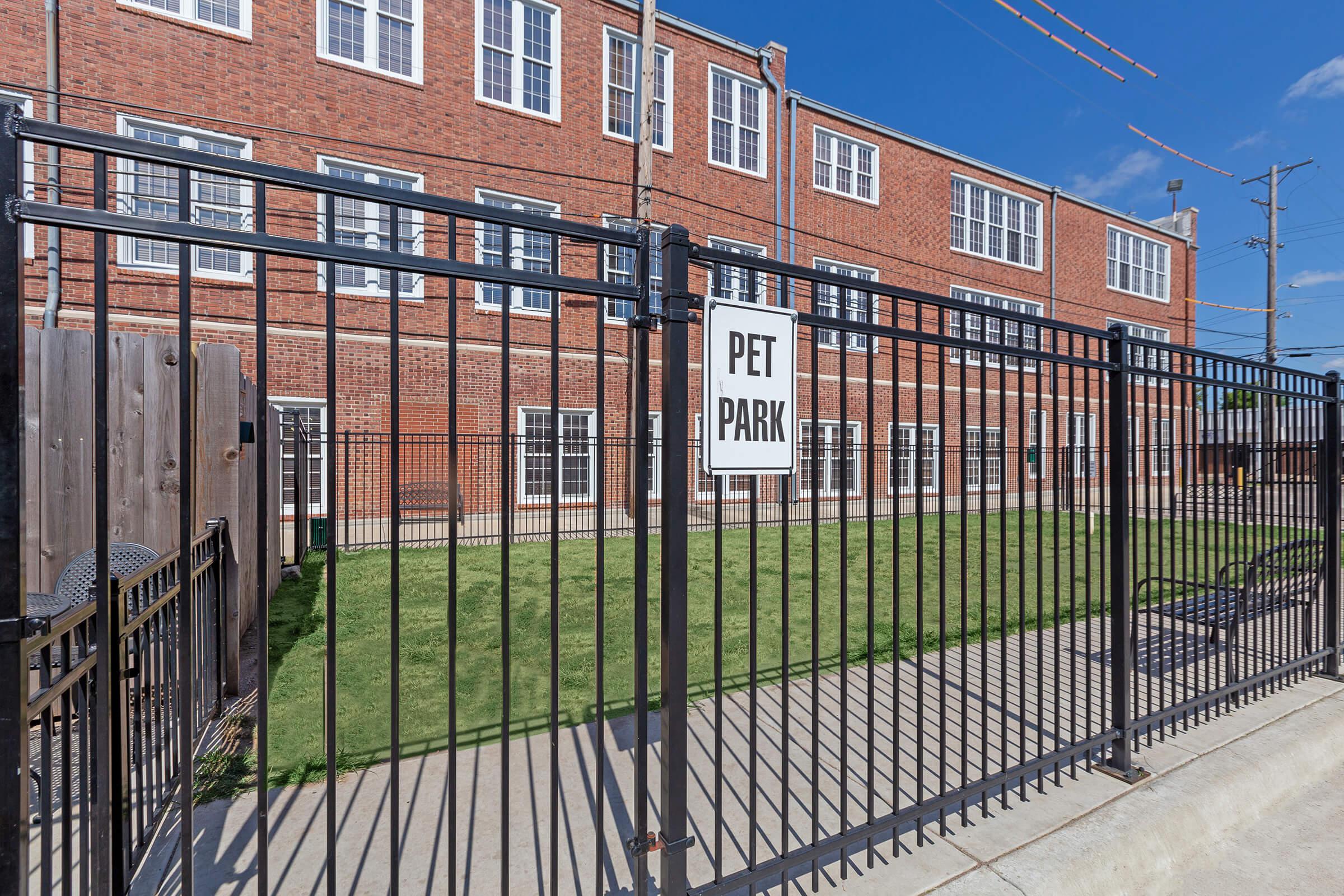 a brick building with a metal fence