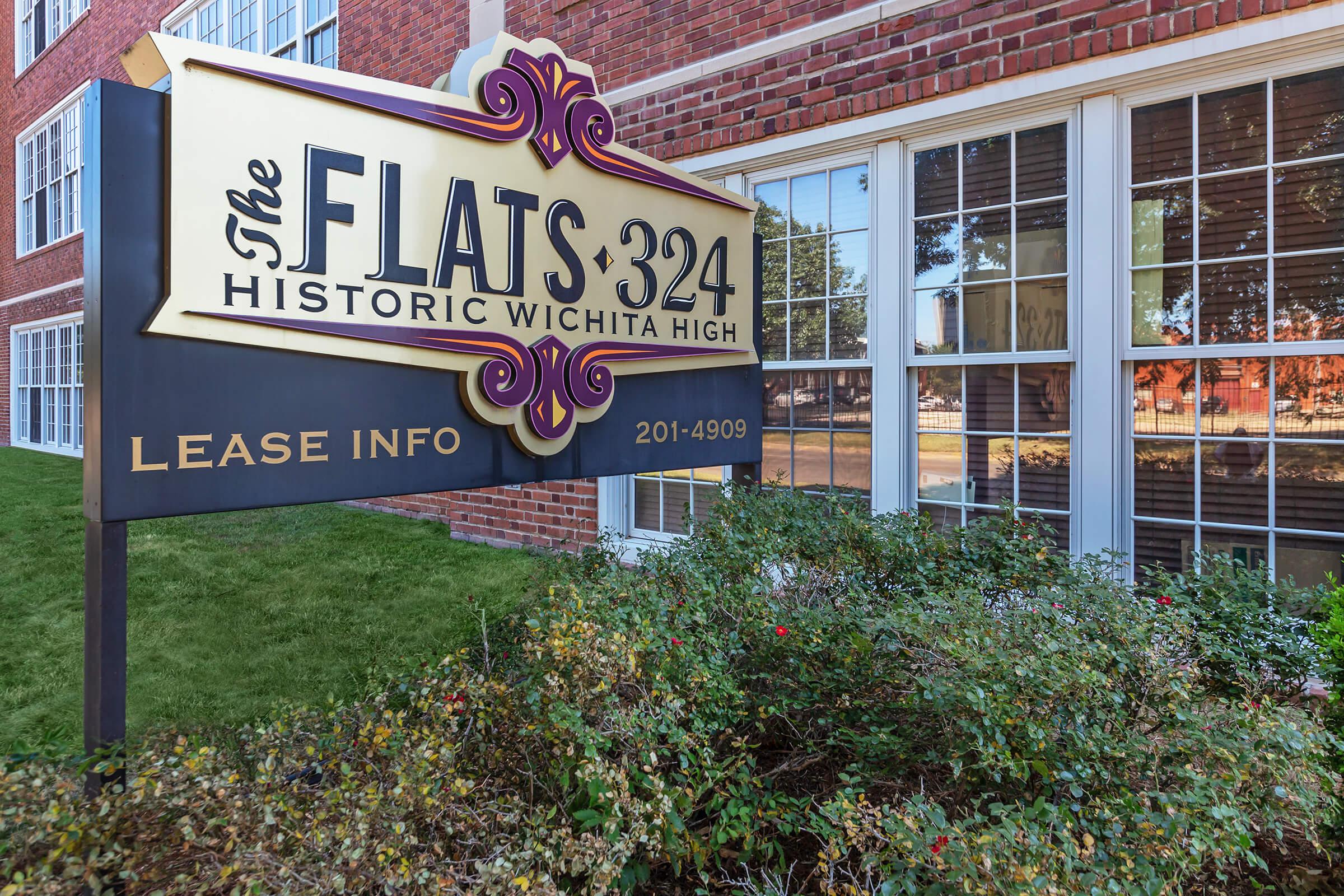 a sign in front of a brick building