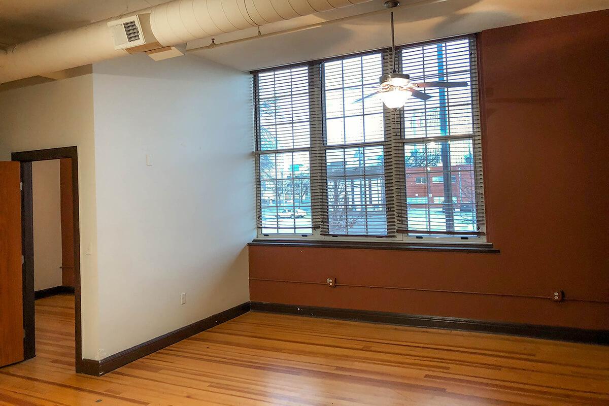 a large empty room with a wooden floor