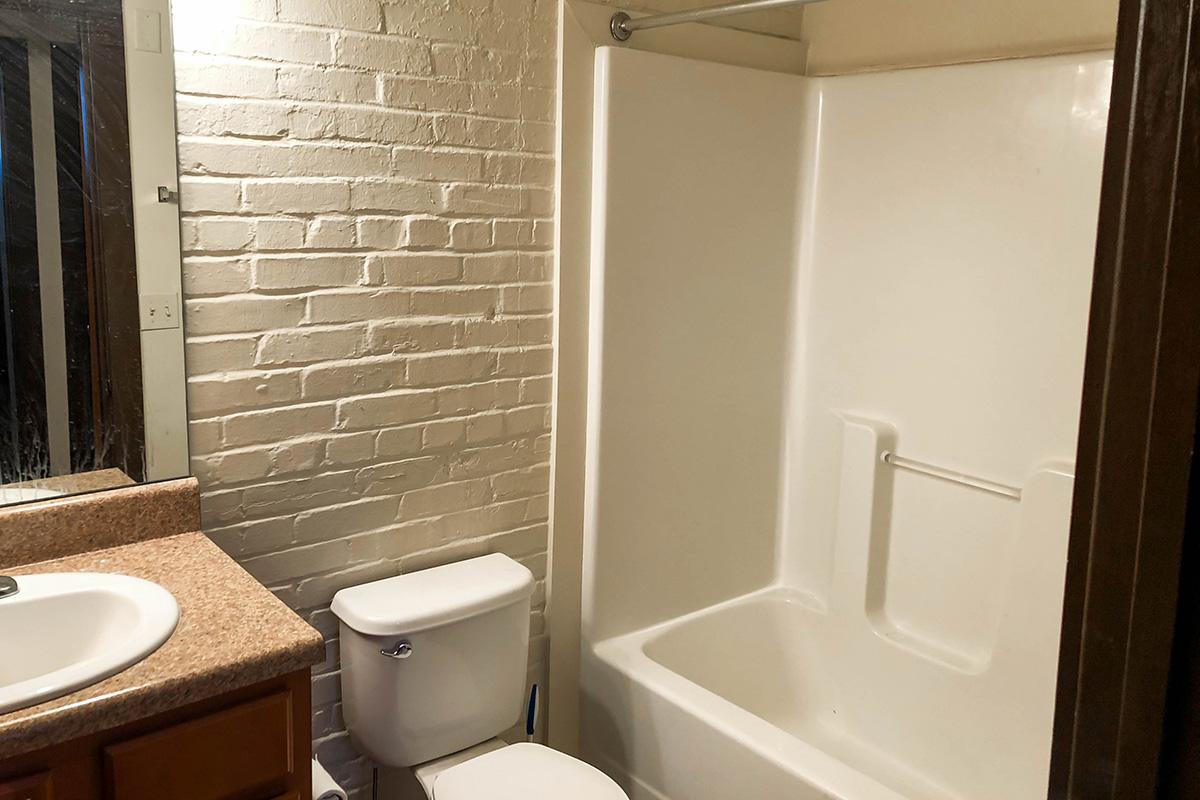 a white tub sitting next to a sink