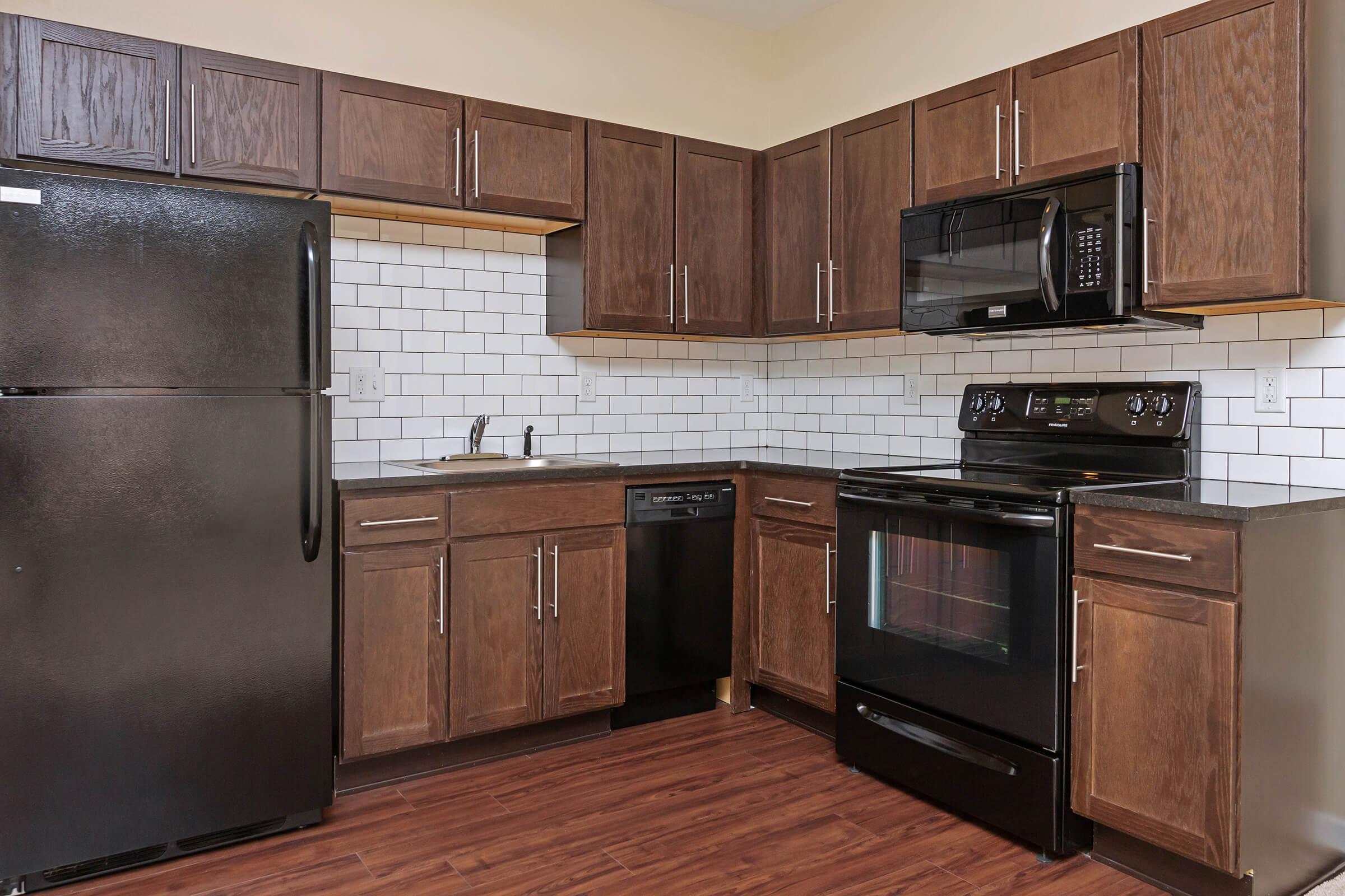 a kitchen with stainless steel appliances and wooden cabinets