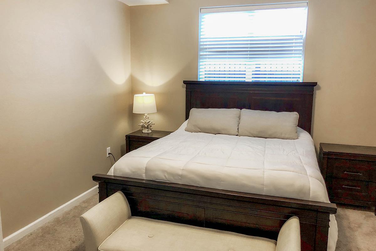 a large white bed sitting in a room