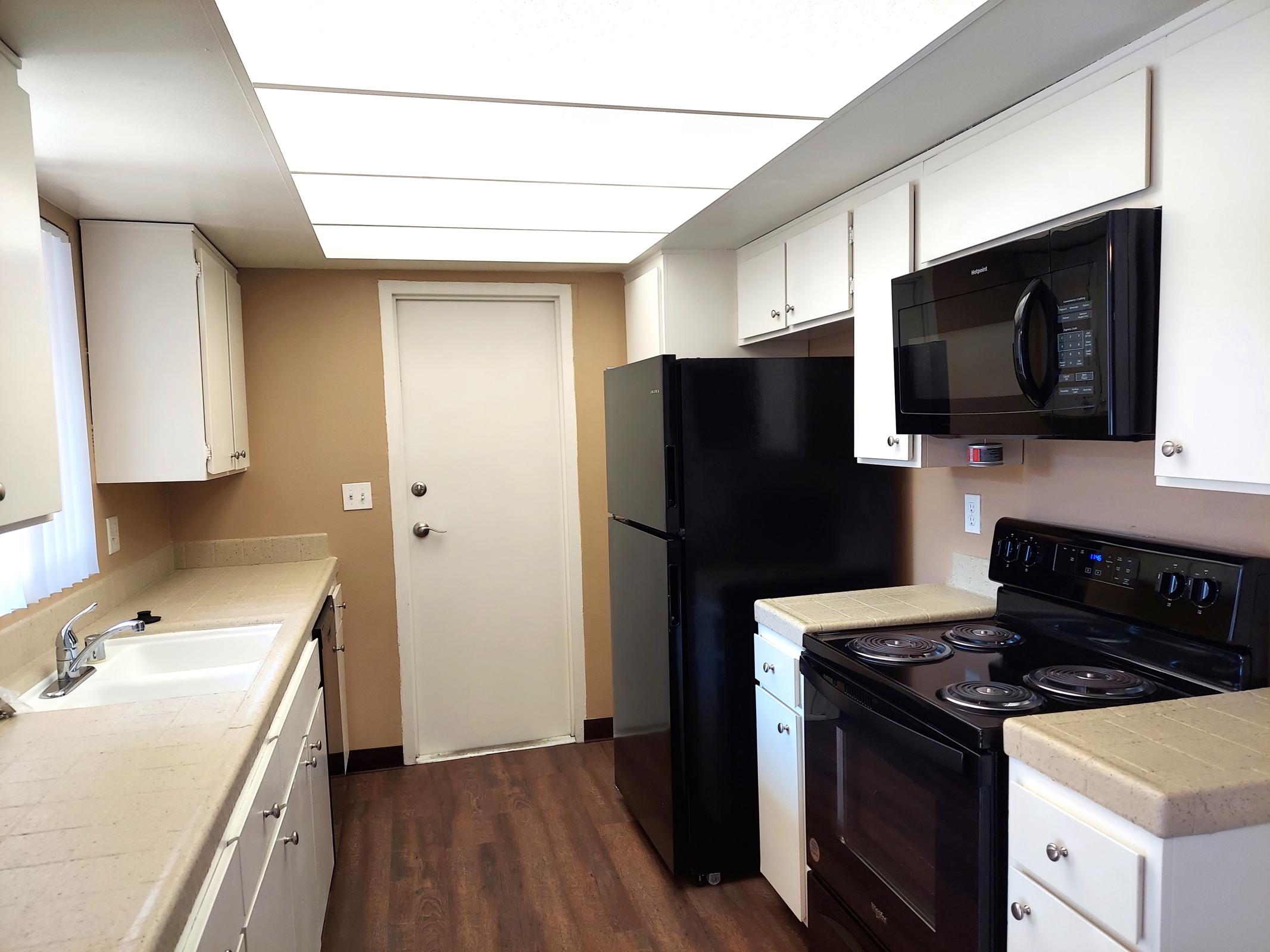 a large kitchen with stainless steel appliances