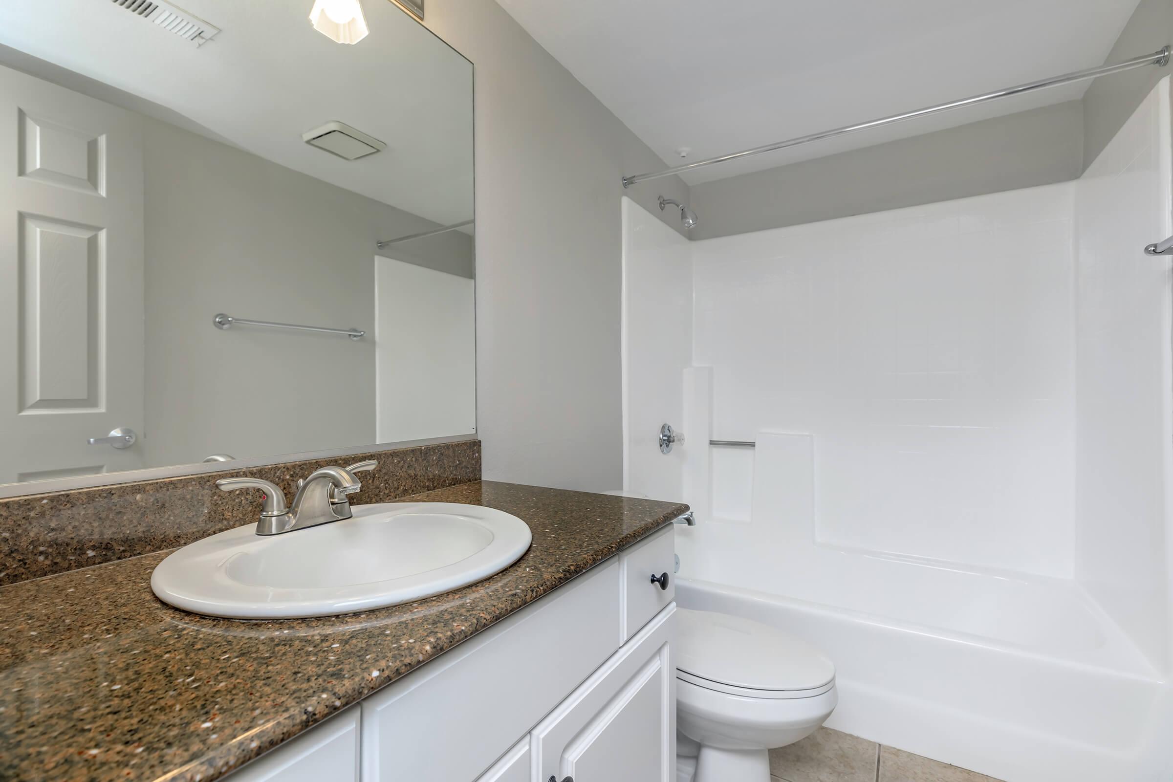 Bathroom with brown countertops