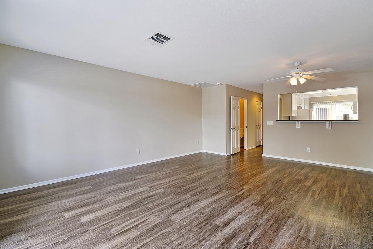 Vacant living room with wooden floors