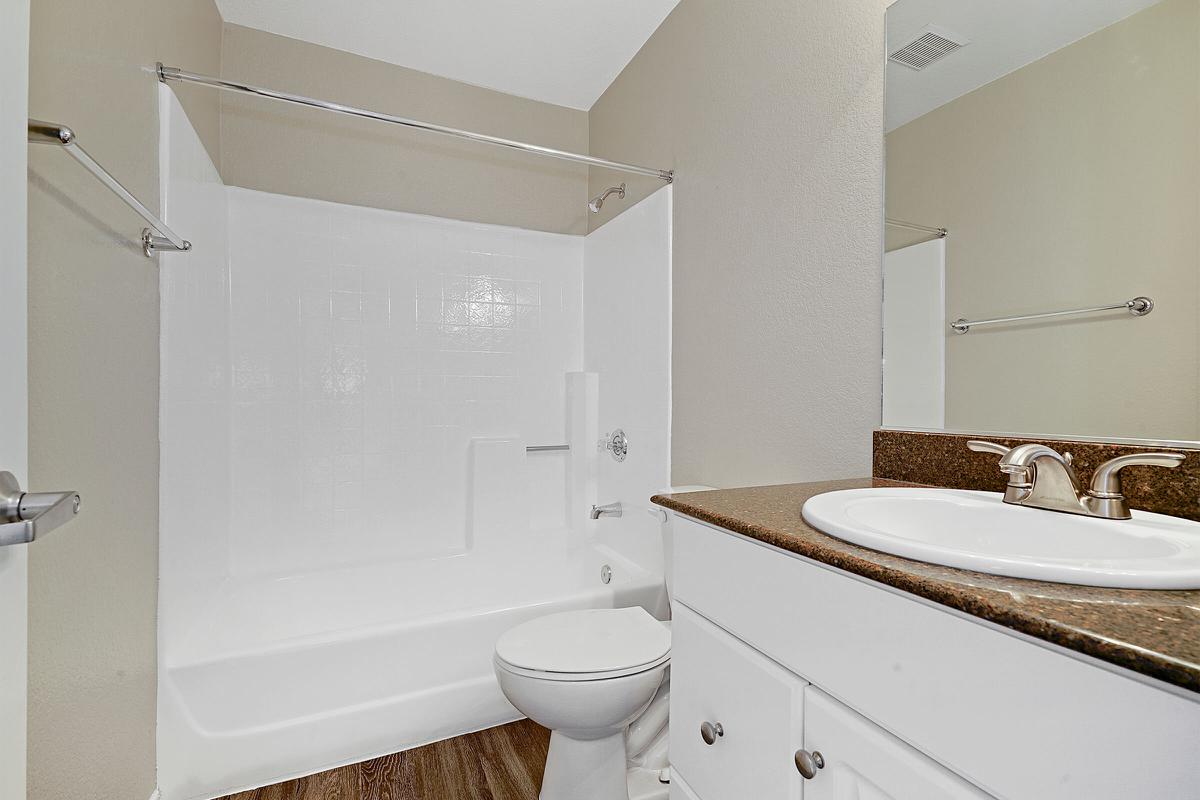 Vacant bathroom with wooden floors