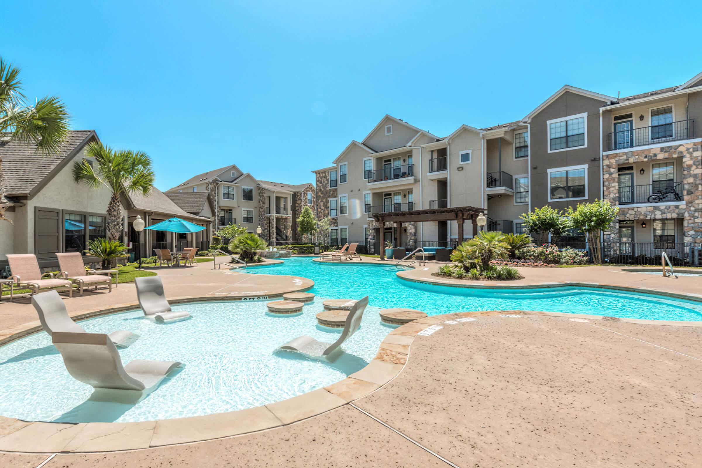 SOAK UP THE SUN BY THE SPARKLING SWIMMING POOL