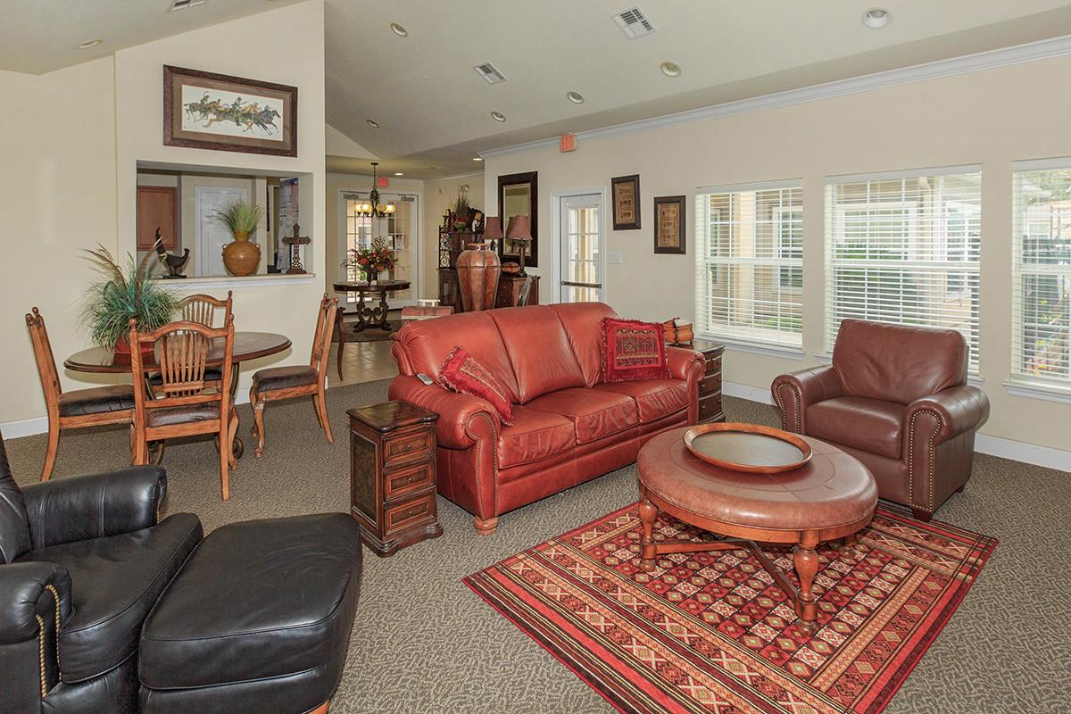 a living room filled with furniture and a red leather chair