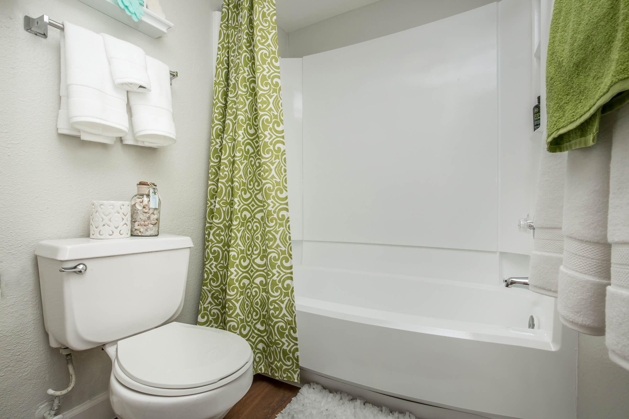 a white sink sitting next to a shower curtain