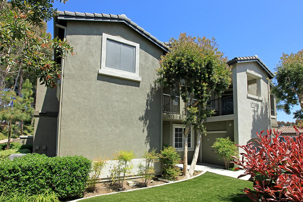 a close up of a flower garden in front of a house