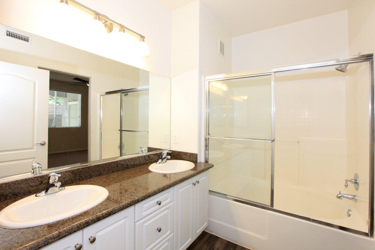 a large white tub sitting next to a sink