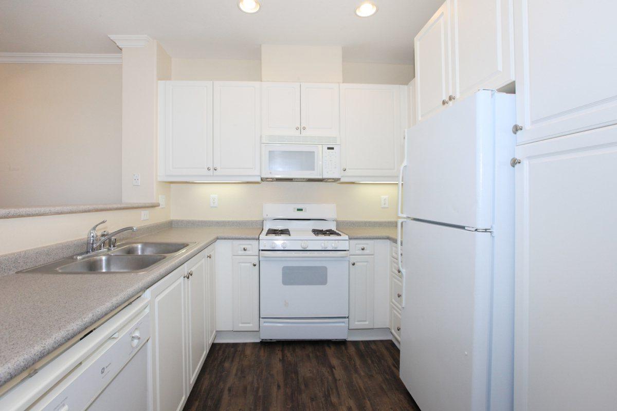 a white refrigerator freezer sitting inside of a kitchen