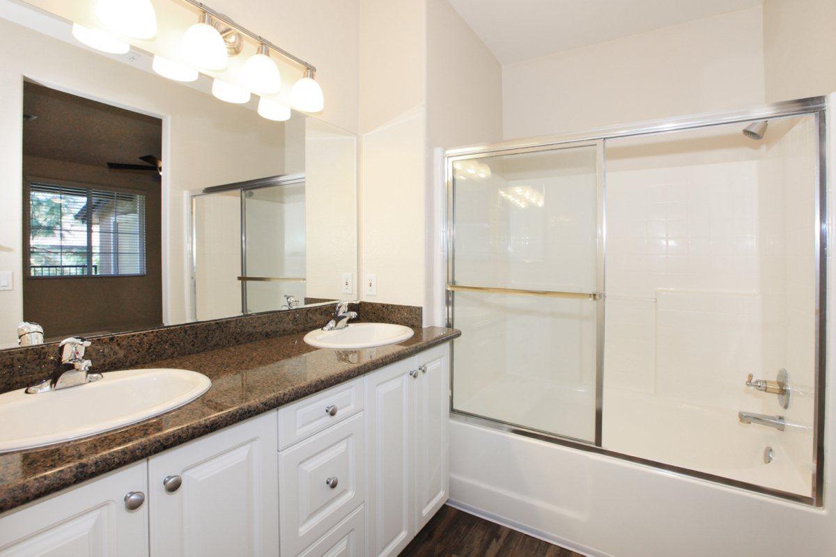 a kitchen with white cabinets and a sink