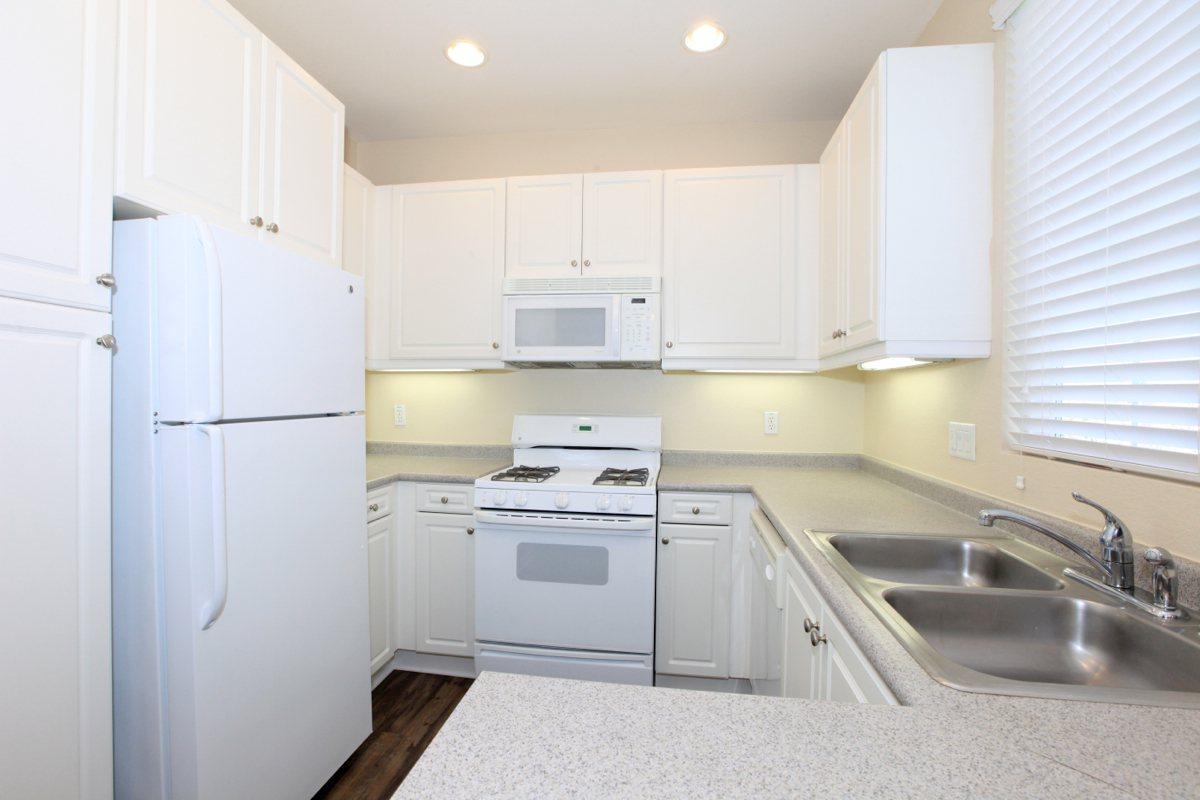 a kitchen with a stove sink and refrigerator