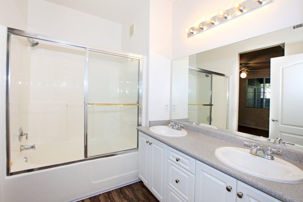 a large white tub sitting next to a sink