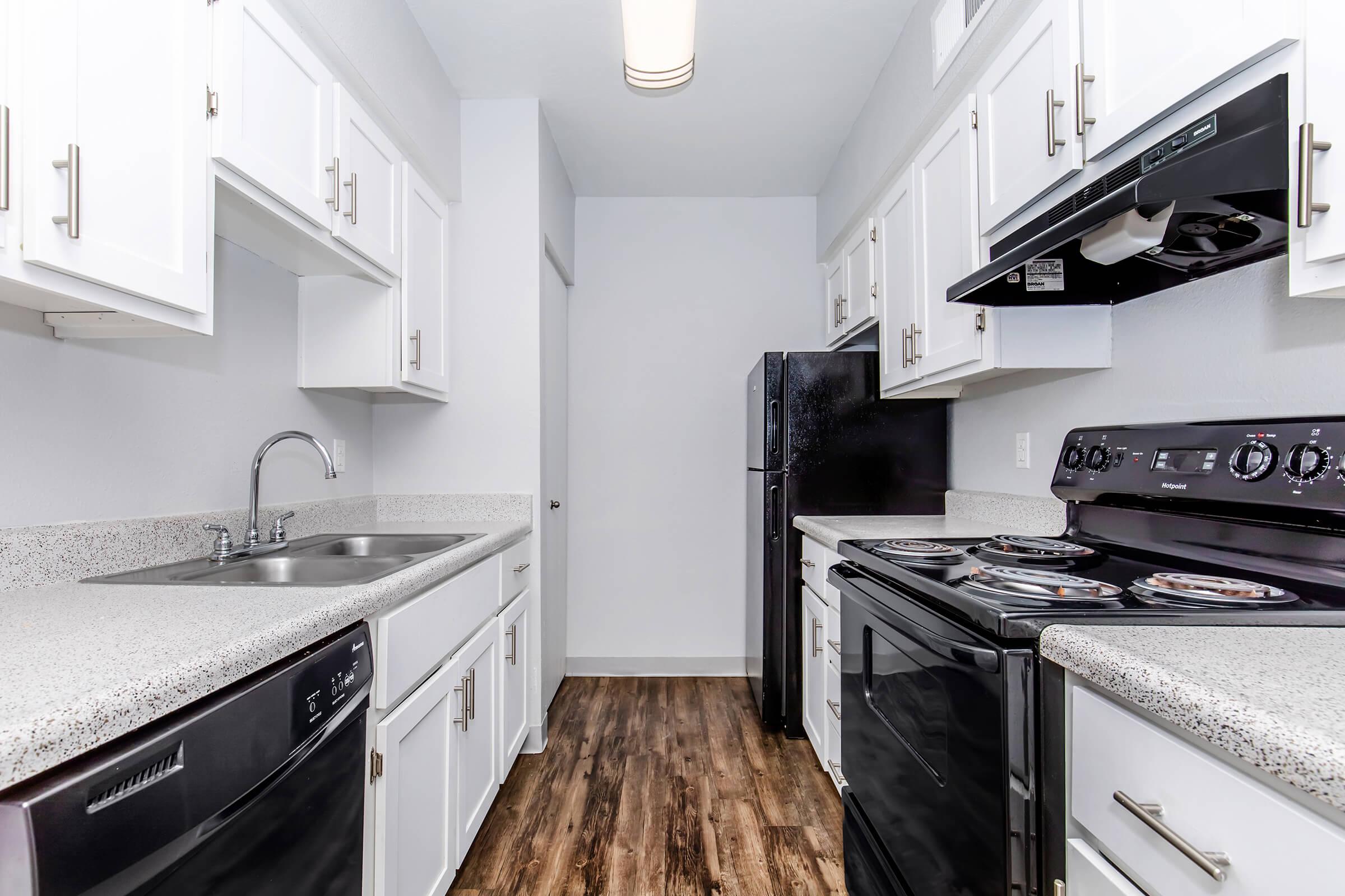 a kitchen with a stove and a sink