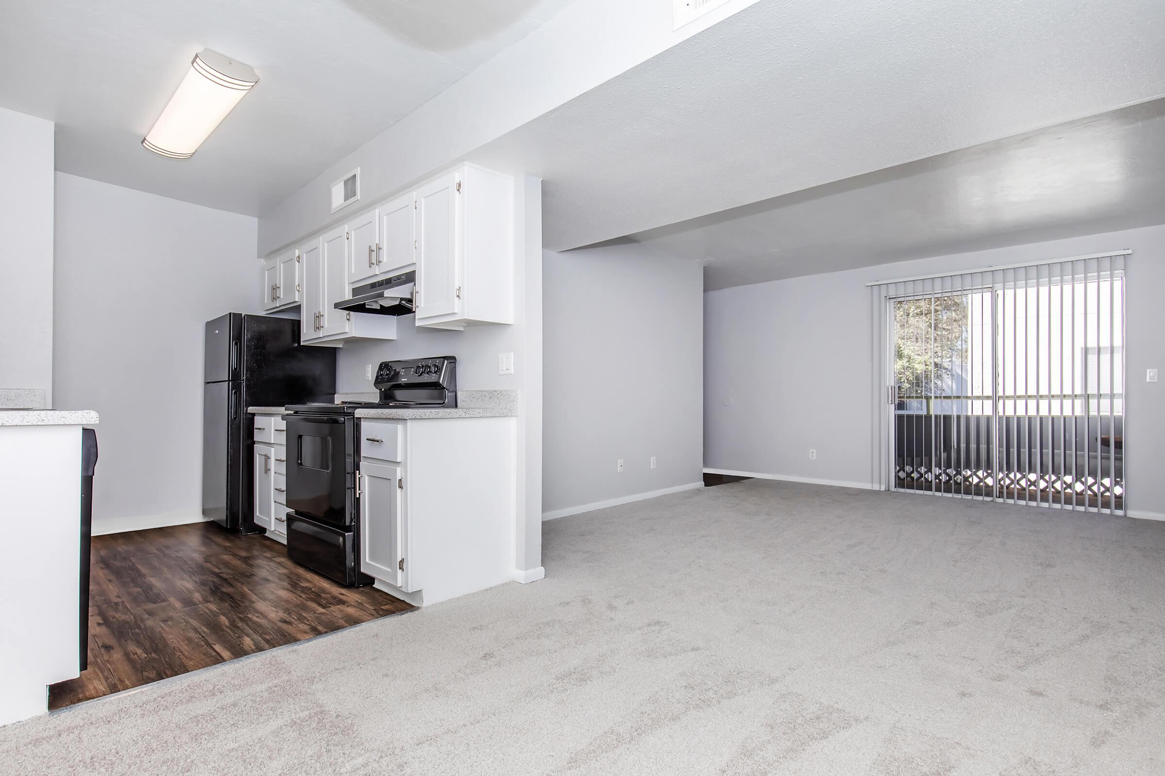 a living room filled with furniture and a refrigerator